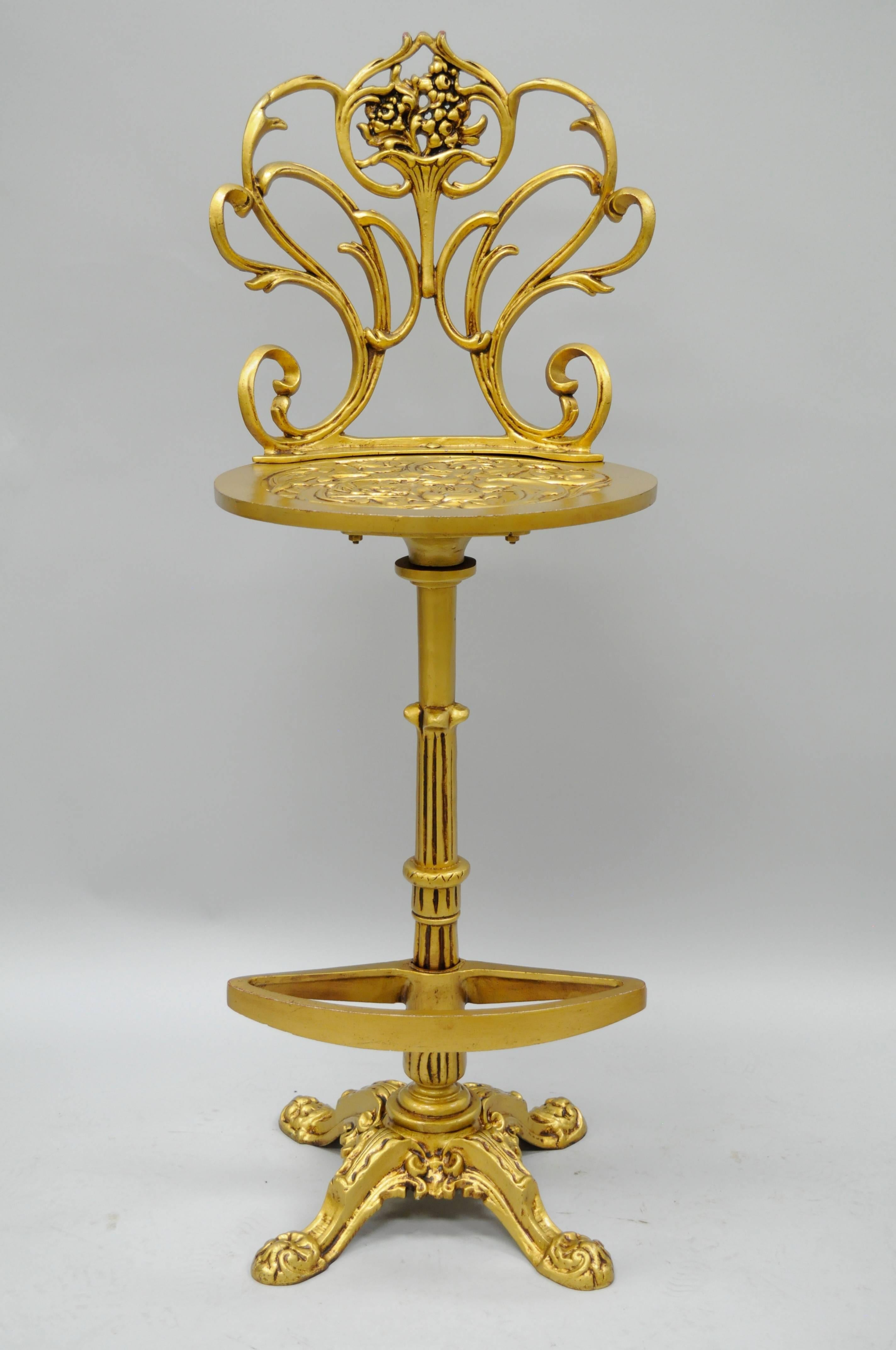 Remarkable set of four vintage swivel and return gold Hollywood Regency / Art Nouveau style cast aluminum bar stools attributed to Arthur Court. The set features swivel and return seats, finely cast floral and scrolling acanthus details to the