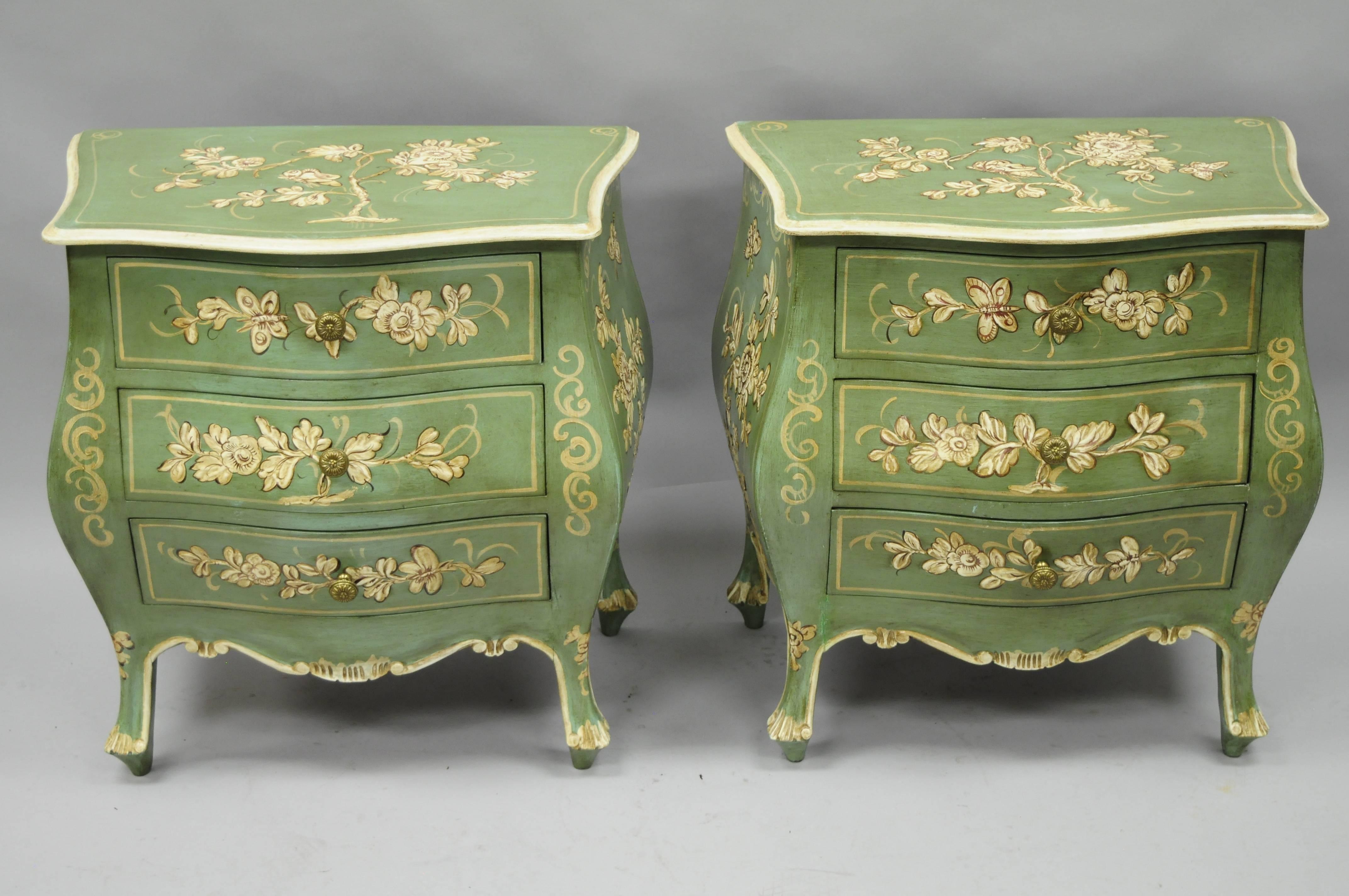 Pair of vintage petite Italian Florentine / Venetian green painted bombe commodes / bedside tables. This adorable pair of tables features an antiqued green painted finish with raised floral details to the face, sides, and tops. Chests further