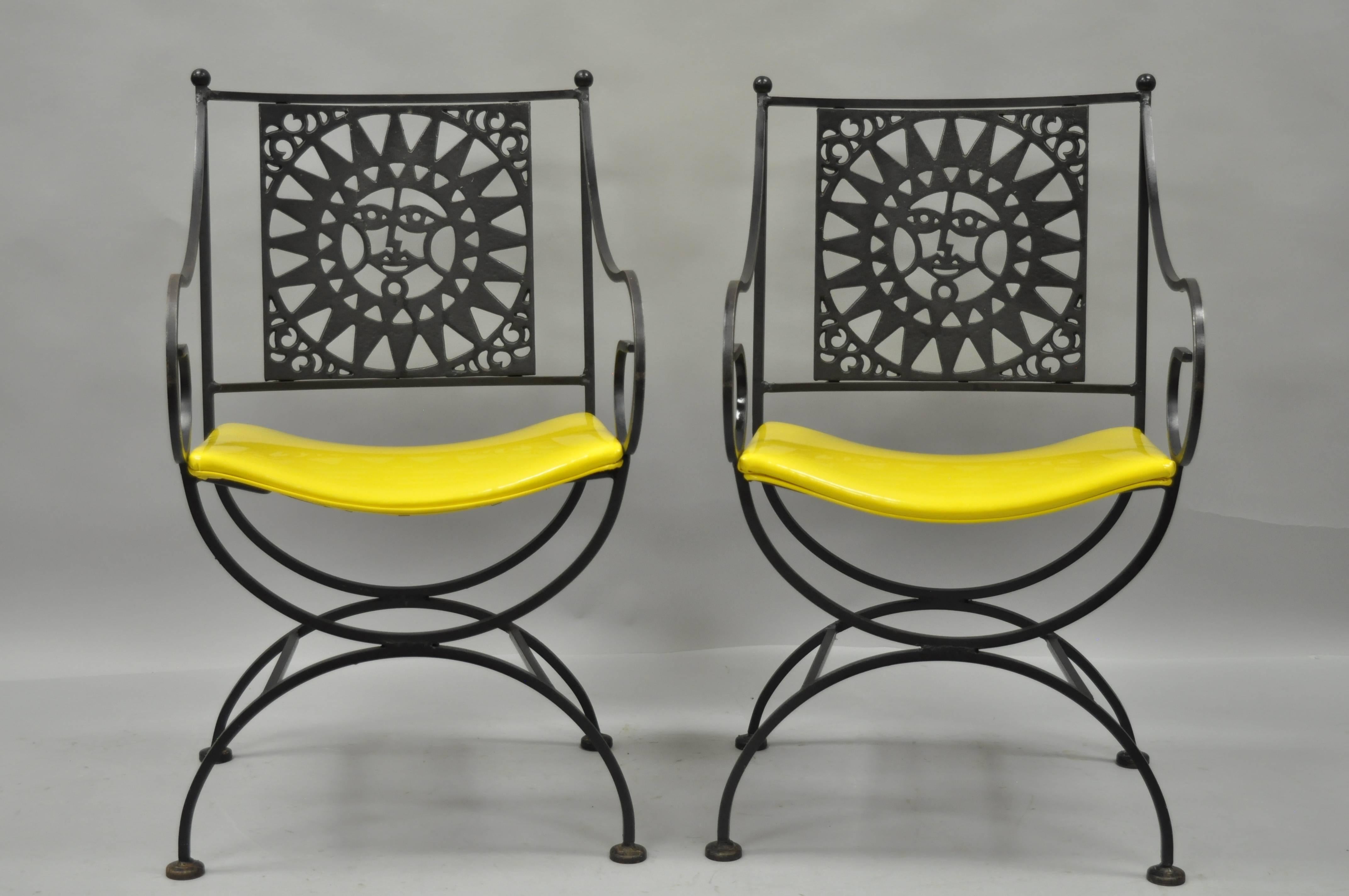 Pair of vintage Mid-Century Modern, 1960s wrought iron directors chairs with sun backs from the Mayan Collection by Arthur Umanoff. This wonderful pair of handcrafted chairs features unique X-form bases, ball form finials, whimsically scrolled arms,