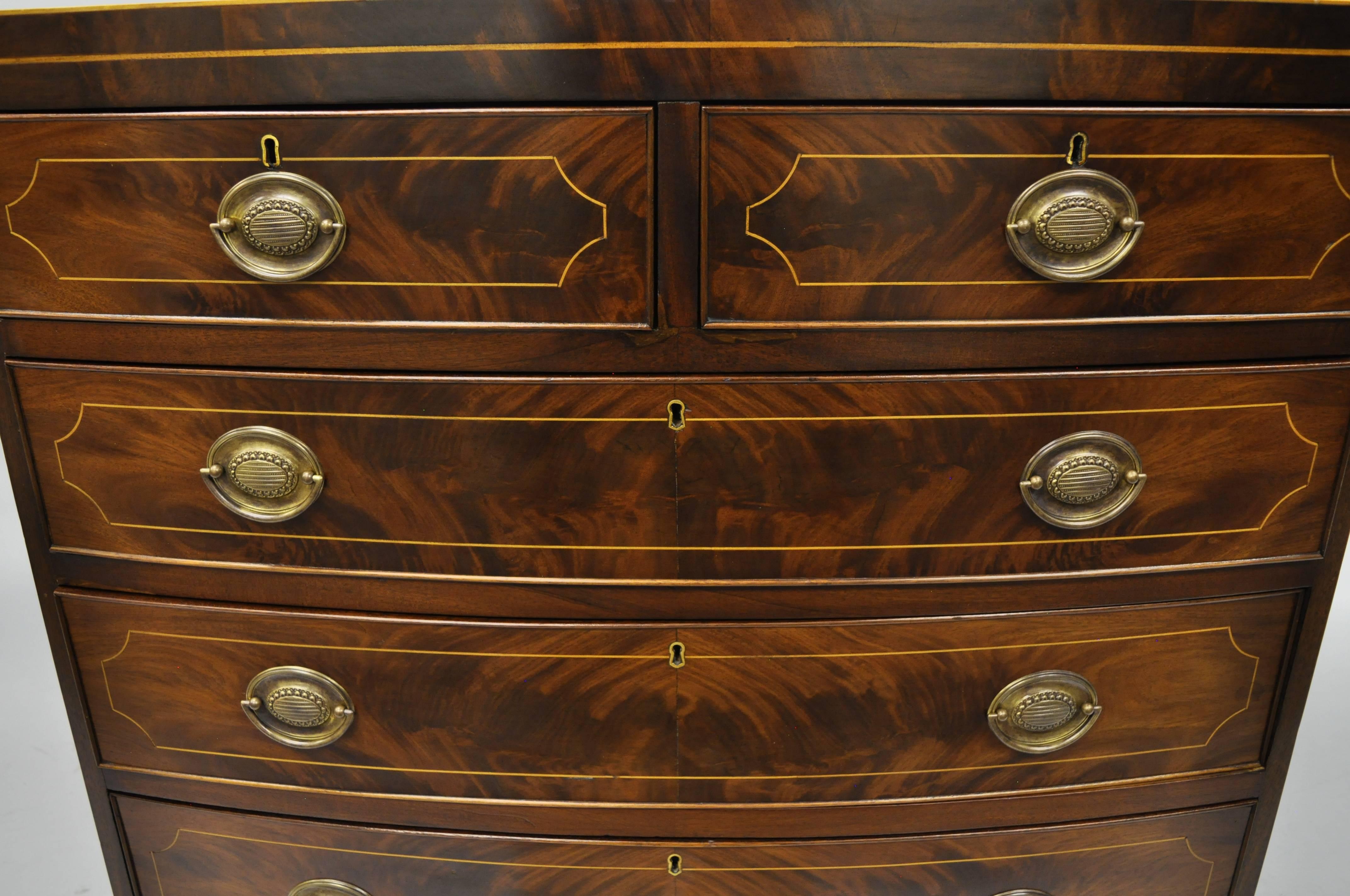 Antique mahogany American Federal inlaid five-drawer chest. Item features beautiful flamed / crotch mahogany veneers, satinwood pencil inlay, five dovetailed drawers, bow front, brass hardware, panel wood backing, all drawers have locks which are