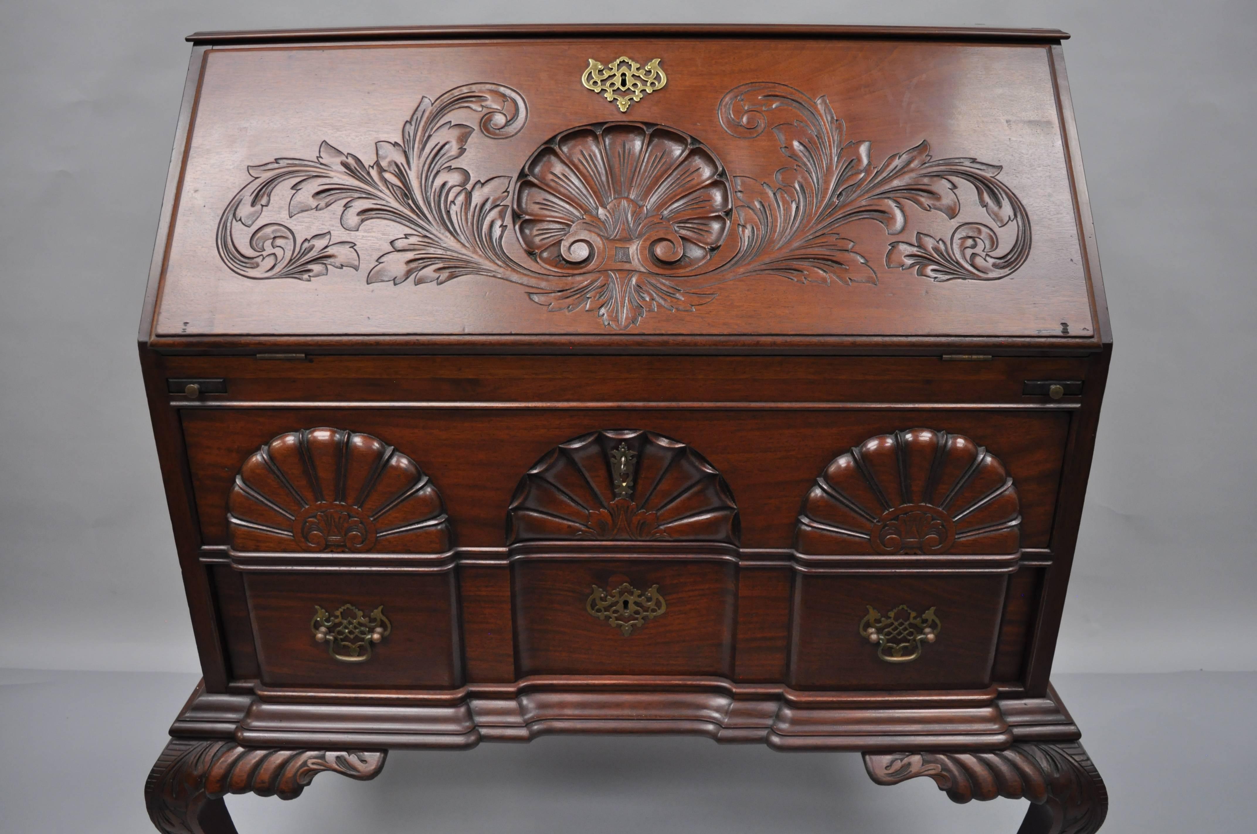 19th century Chippendale style mahogany blockfront secretary desk. Item features solid mahogany wood construction, dramatic shapely legs terminating with ball and claw feet on the front and back, carved knees, two dovetail constructed drawers, and