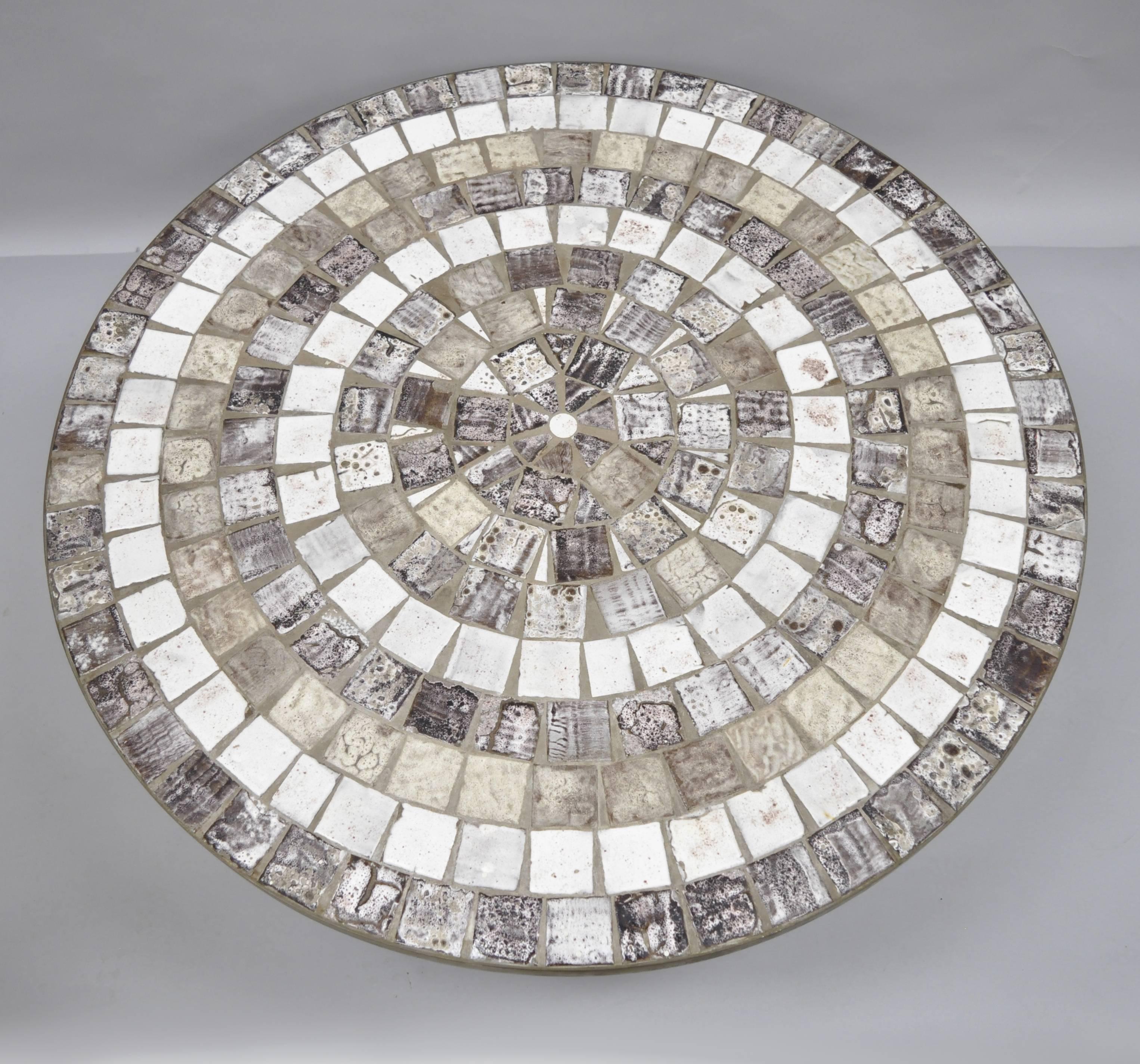 Vintage Mid-Century Modern mosaic tile top bronze base round coffee table in the manner of Roger Capron. Item features a stunning mosaic ceramic tile top, thick bronze band with straight bronze legs raised on square pads. Bronze has achieved a warm