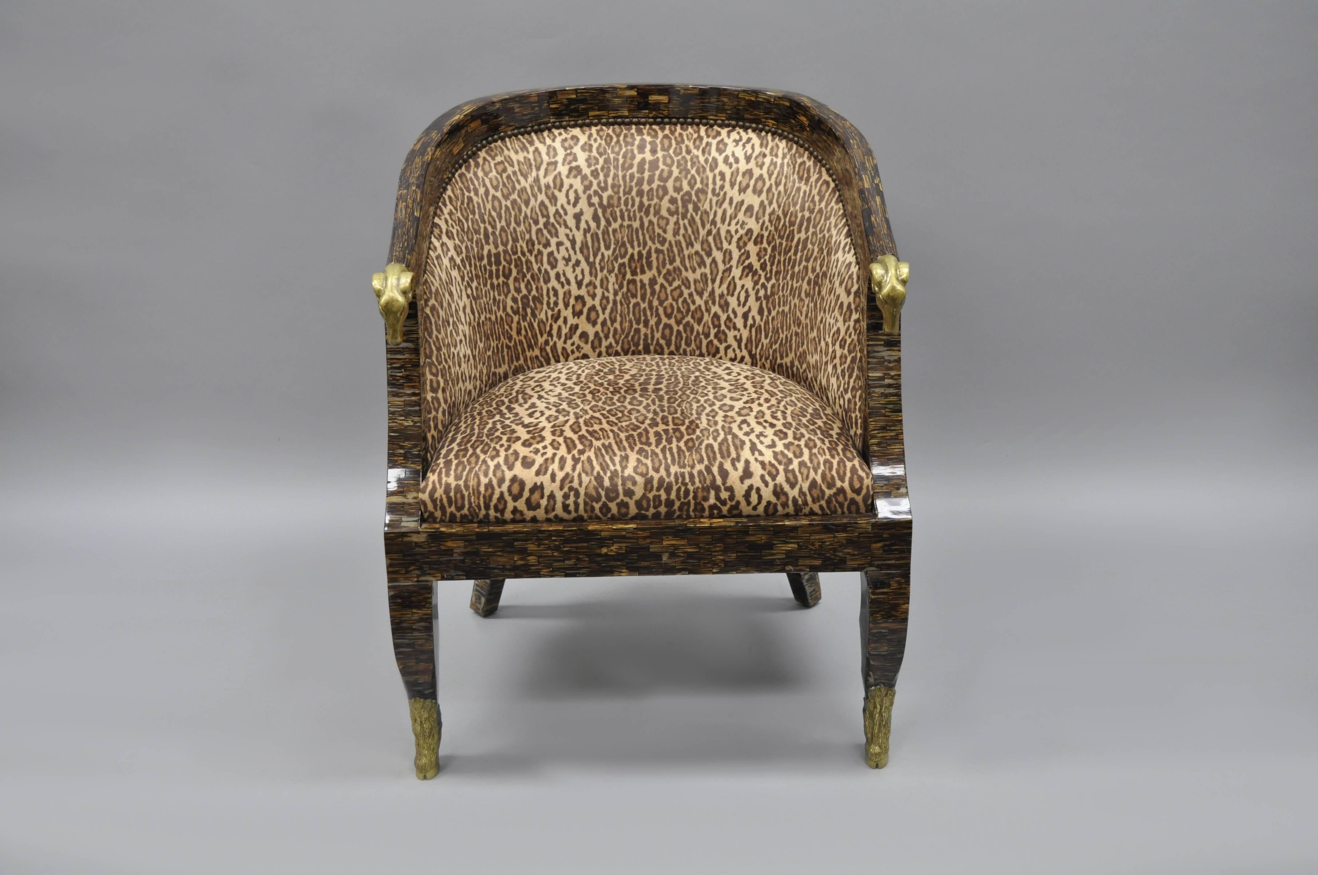Unique cheetah print horn veneer barrel back club chair in the Regency / French Empire style with bronze ram's heads and hairy hoof foot. Item features finely cast bronze ormolu, shapely legs, cheetah print upholstery, and a faux tortoise color