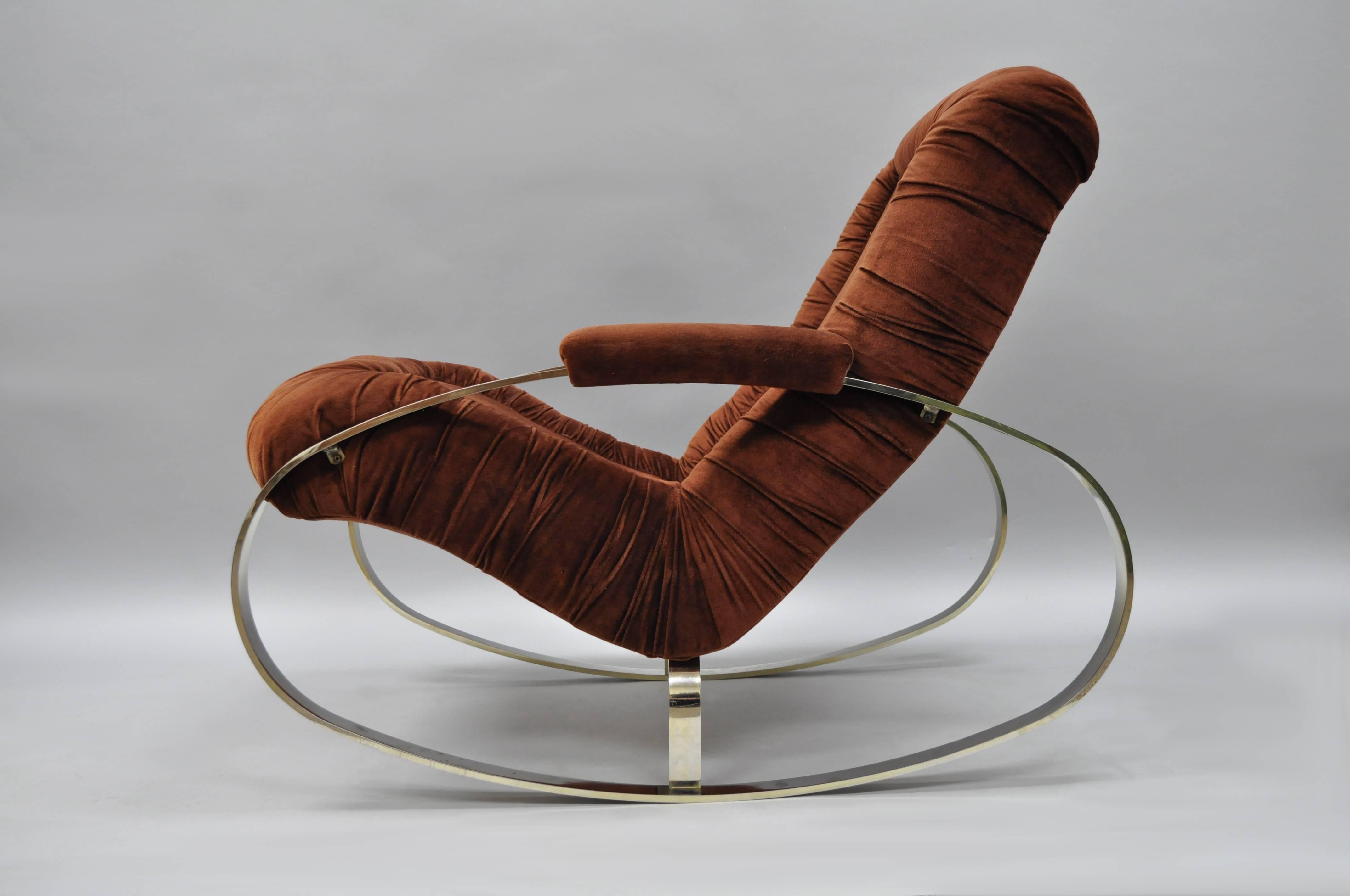 Vintage Italian Mid-Century Modern steel frame rocking chair by Guido Faleschini. Item features a heavy ovoid shaped steel frame with chrome/bronze finish, upholstered armrests, and original rust color fabric.