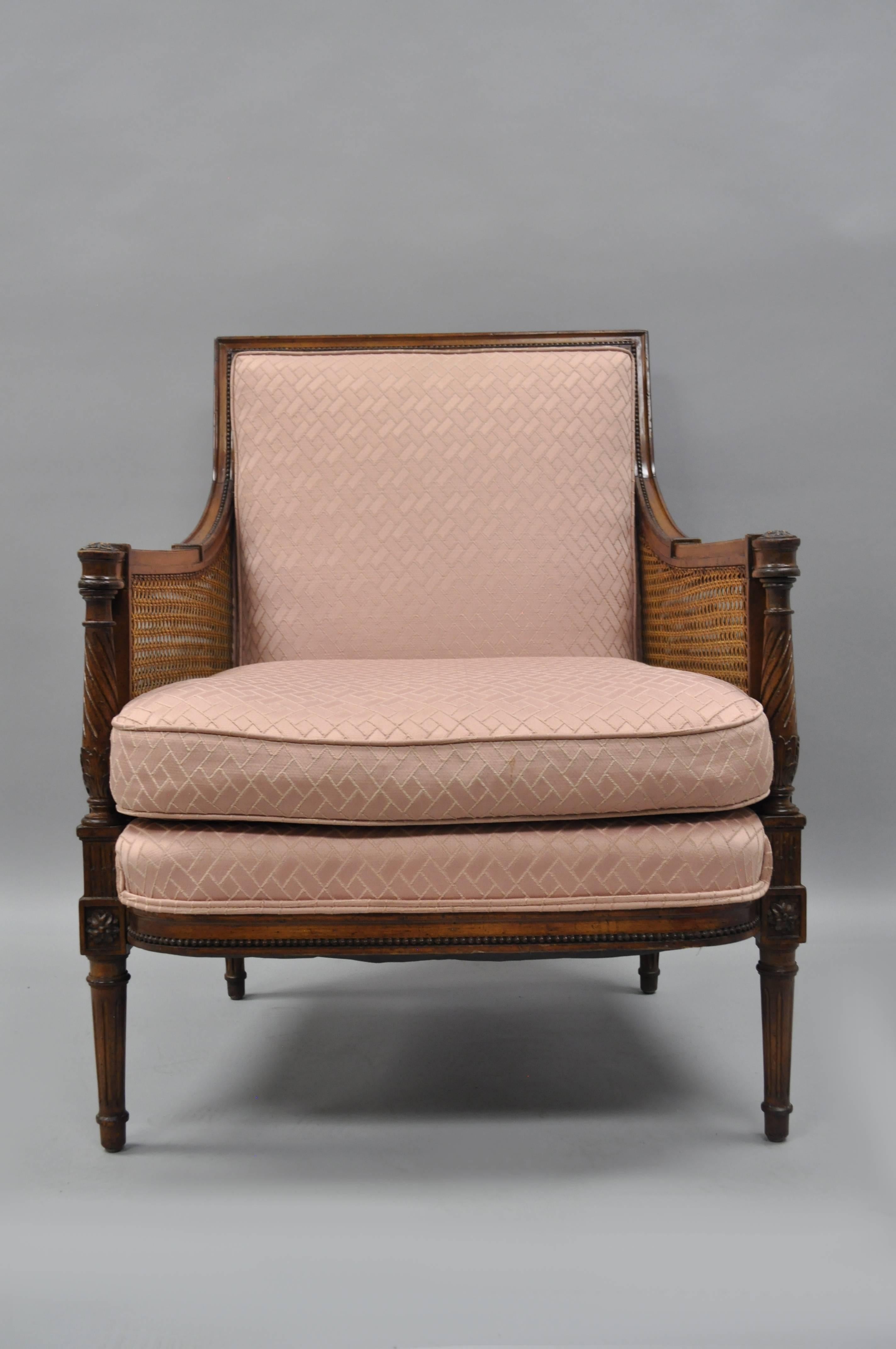 Vintage French Louis XVI / Directoire style cane Bergere armchair. Item features double cane sides, spiral carved supports, reeded and tapered legs, tight upholstered square back with loose seat cushion, and classic Louis XVI form.