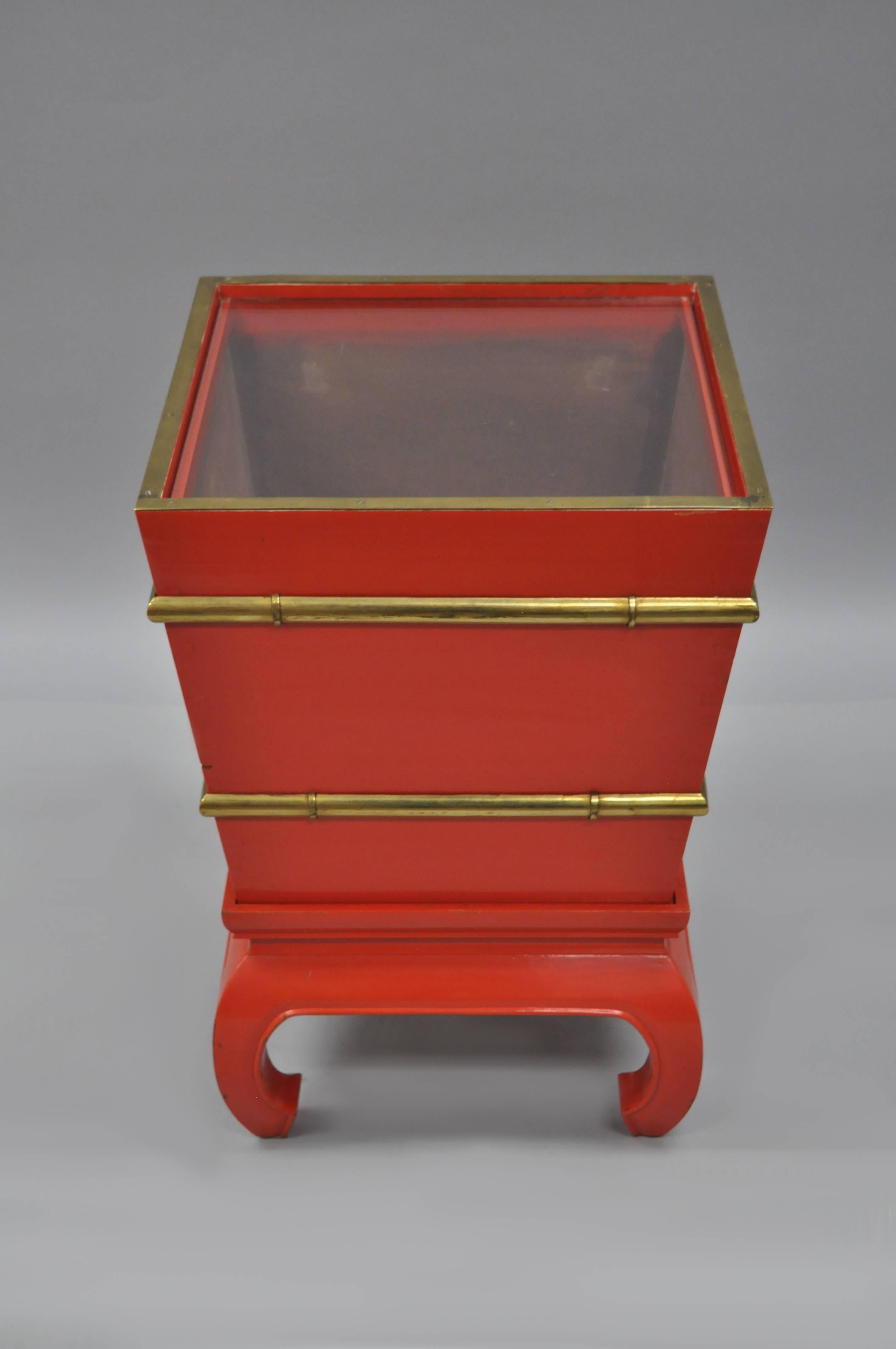 Unique vintage chinoiserie red lacquered solid wood accent table on base. Item features 2 part solid wood dovetail construction, inset removable glass top, open interior, solid brass faux bamboo details and trim, heavy brass handles on two sides