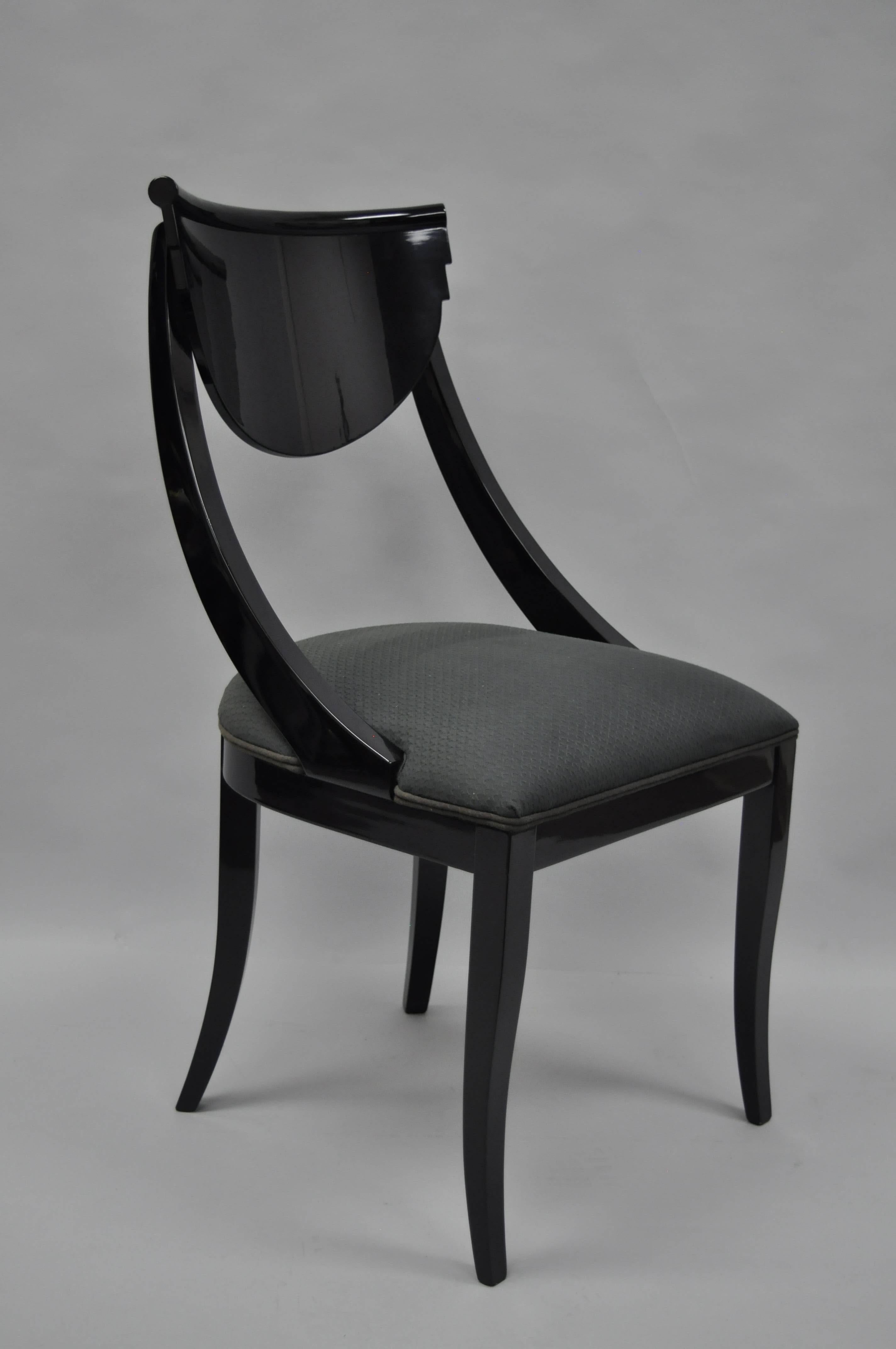 Very classy black lacquer and gold Trim Carlton House desk with matching lacquered chair in the neoclassical/Regency style by Maitland-Smith. Desk features an attractive half-round form with slightly tapered legs, nine drawers, brass hardware, and