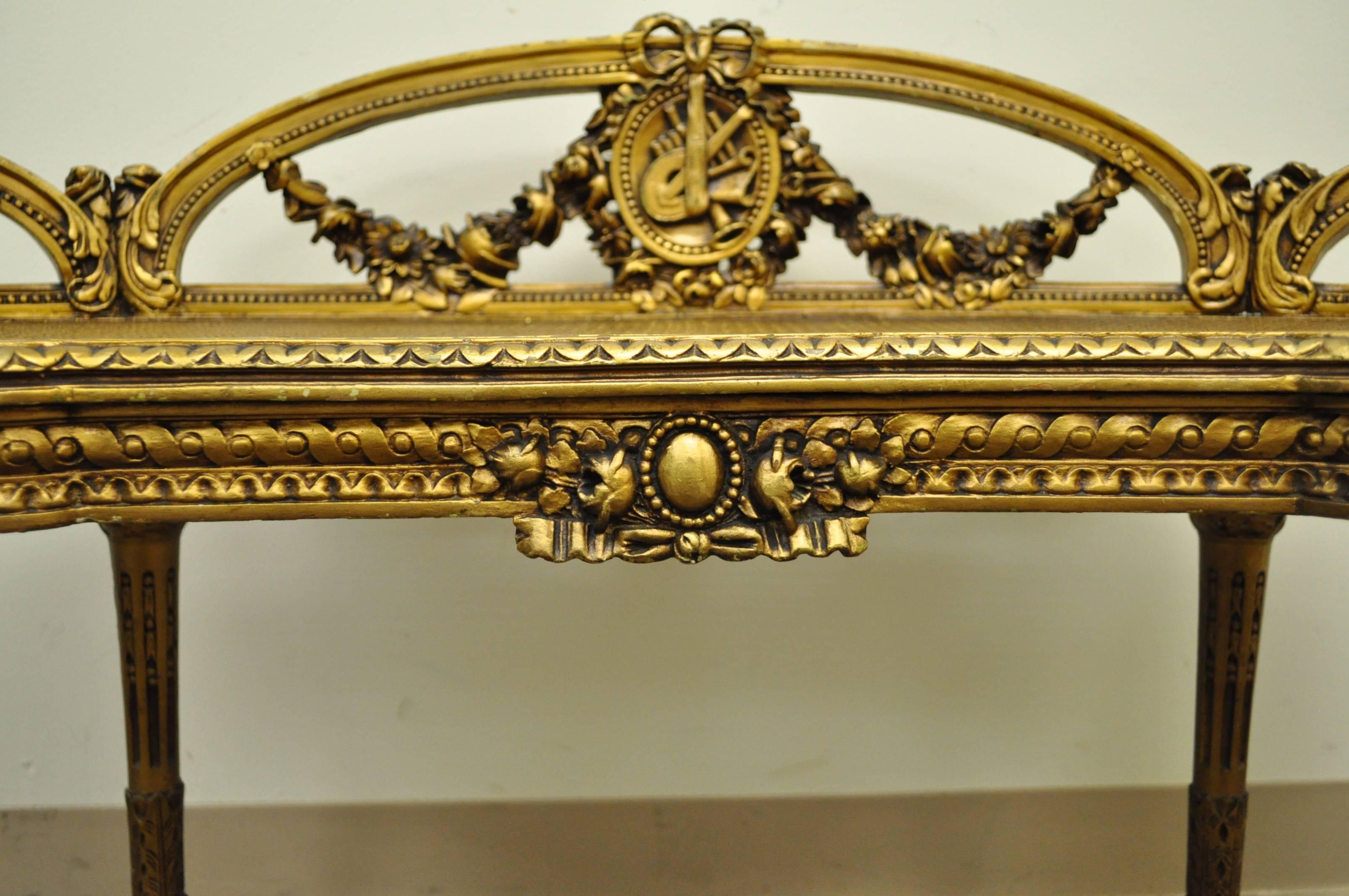 Beautifully carved, giltwood and gesso French vanity bench in the Louis XVI / Victorian taste, circa early 20th century. This wonderful item features a kidney shaped solid wood frame, carved as well as applied detailing including floral drapes, and