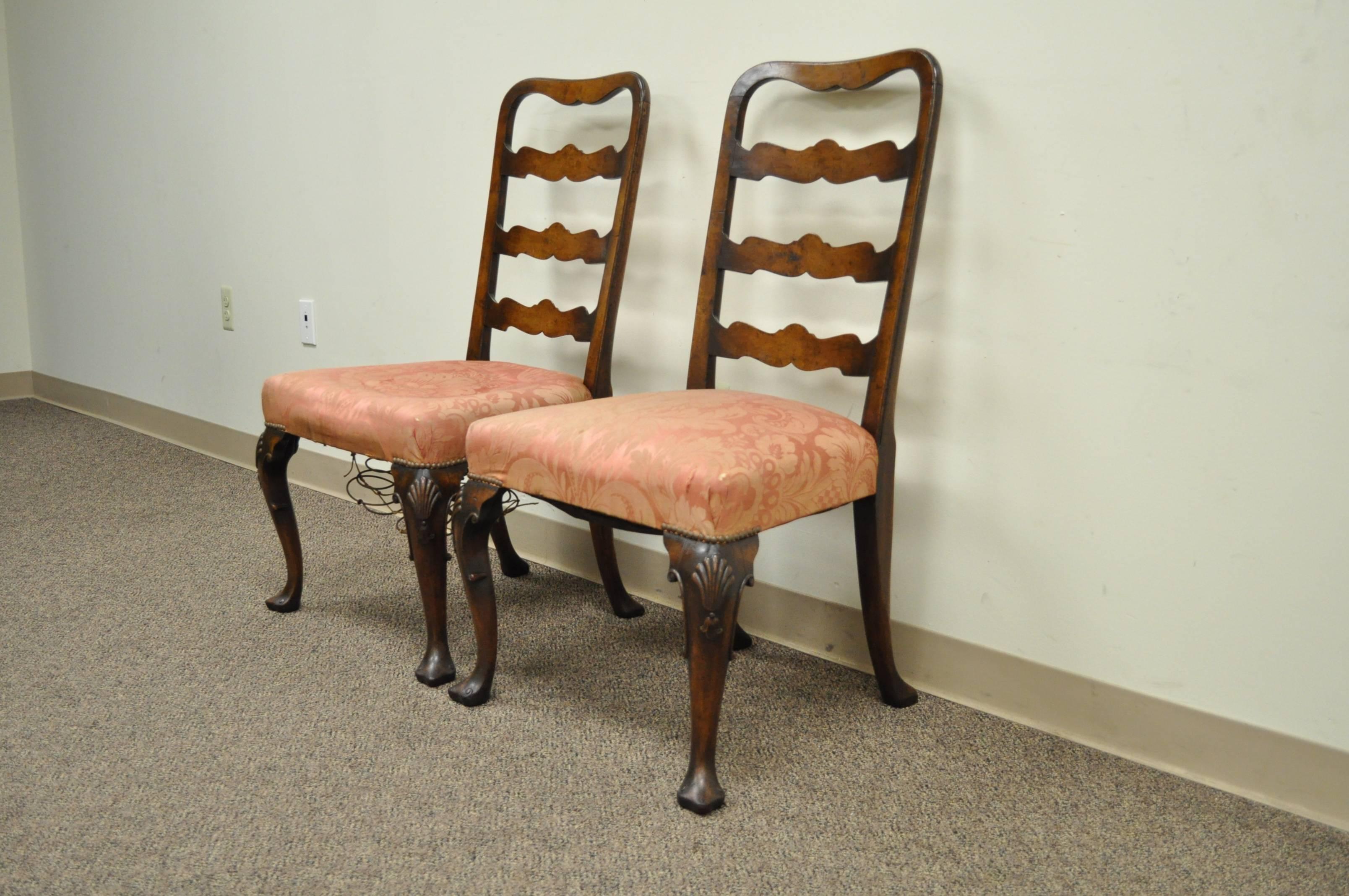 Remarkable pair of hand carved walnut, 18th Century, English Ribbon Back Side Chairs. The chairs feature hand carved and beveled edge rungs, shell carved knees, shapely cabriole legs, trifid footed, and a great overall patina to the wood. The