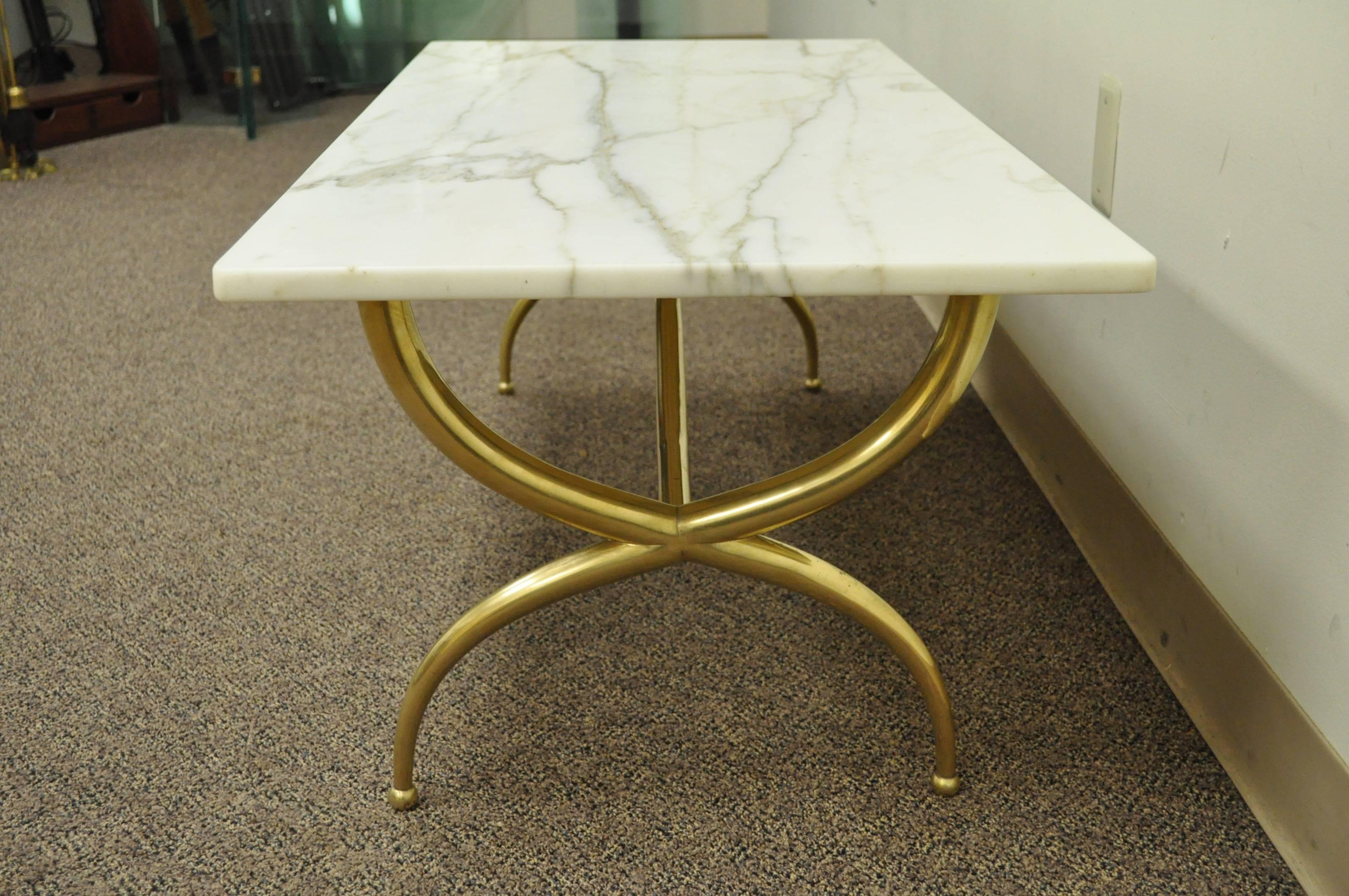 Stunning Brass and Marble Italian Modernist Rectangular Coffee Table in the style of Gio Ponti. The table features X-Form Legs terminating at ball form feet, shaped stretcher base, and a beautiful .75