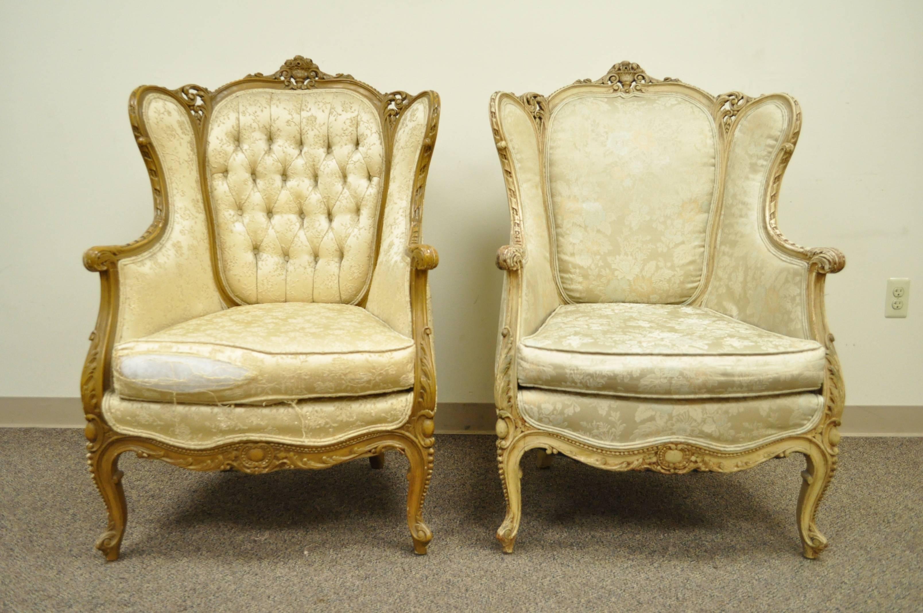 Fantastic Pair of French Bergeres from the early 20th Century. The chairs feature finely carved floral and acanthus frames, shapely cabriole legs, nice wing backs, and elegant overall form. The chairs have the same carved frames with different