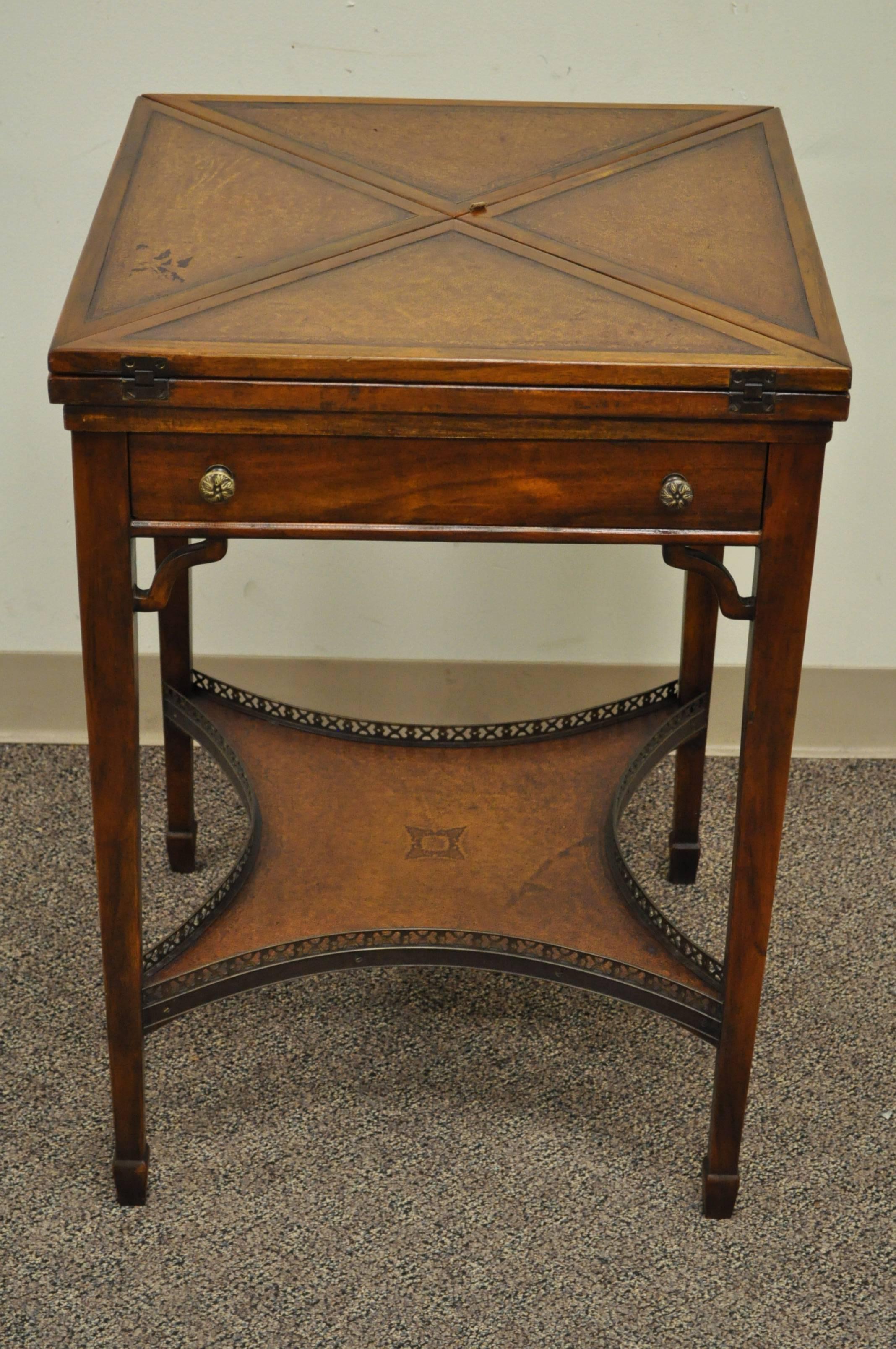 High quality, early 20th century, English game table. Item features a tooled leather top with napkin folding corners which exposes the tooled leather game table surface. Lower section features a tooled leather surface and brass gallery. Single