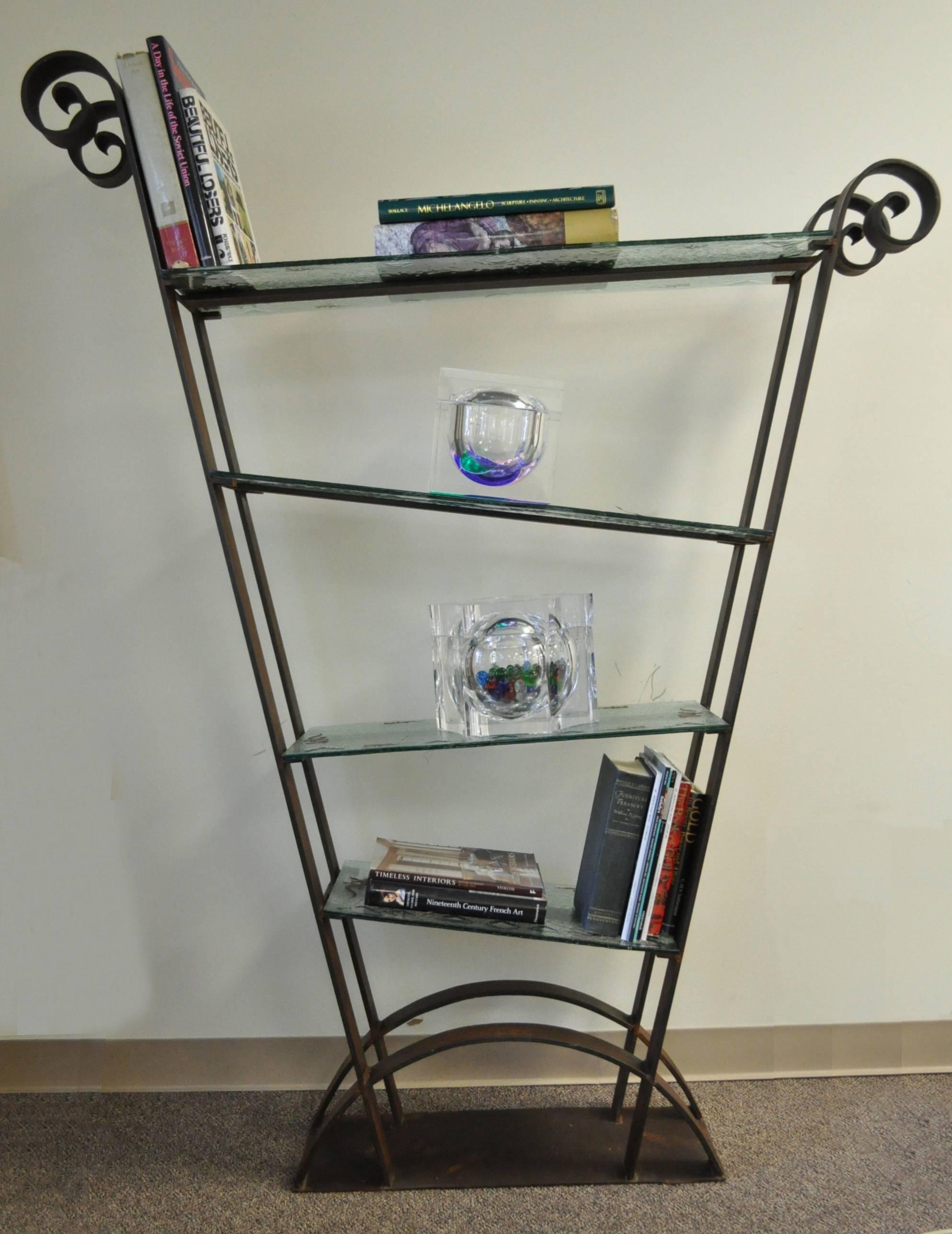 One of a kind vintage iron and glass, artisan crafted, ètagerè or bookcase in the Brutalist style. Item features a heavy solid iron scrolling frame with remarkable sculptural form. There are four 3/8