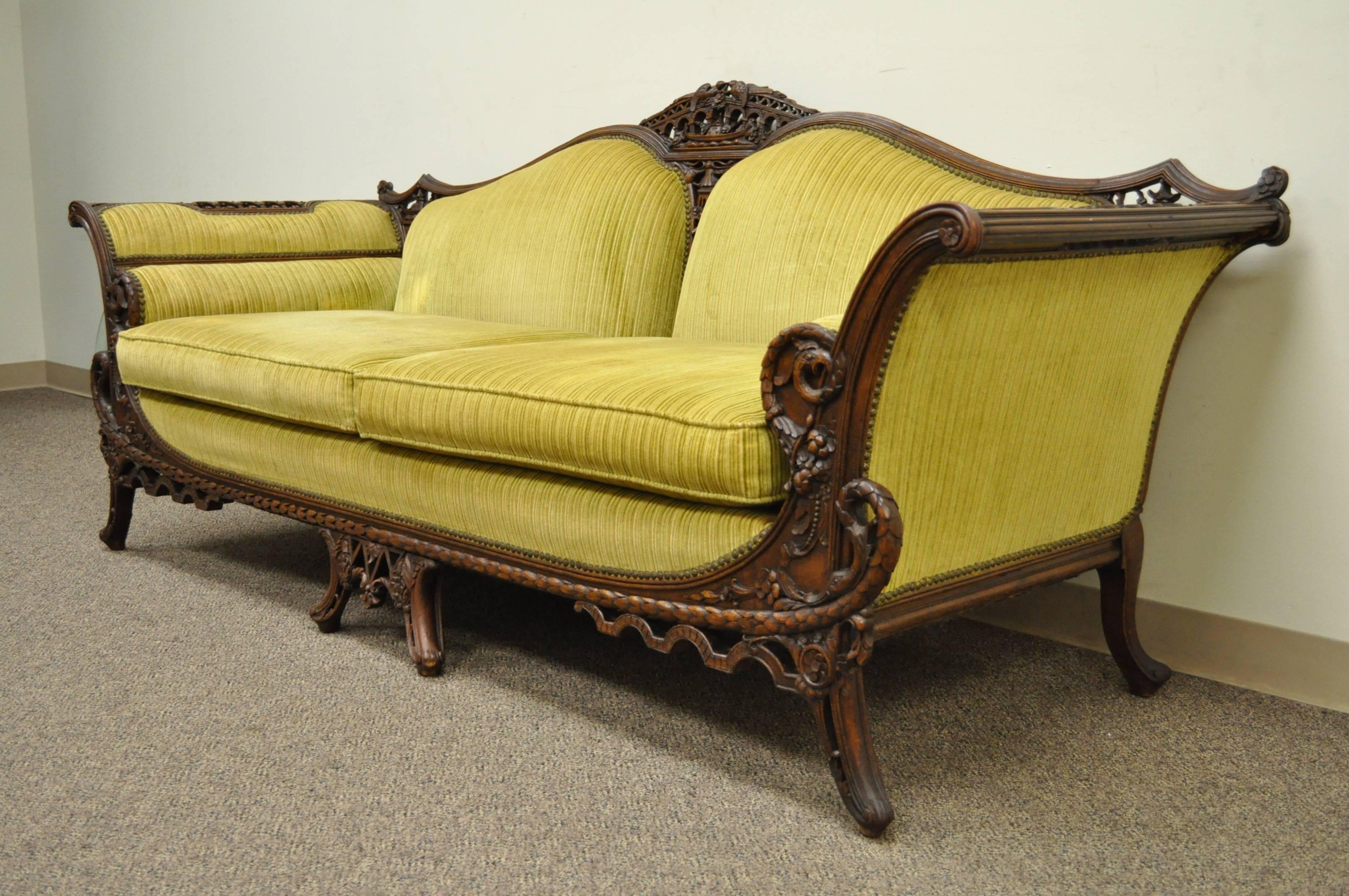 Remarkable, hand-carved, Mahogany sofa from the early 20th century in the transitional Chinese Chippendale style. Item features a number of very fine and detailed carvings including, birds, serpents, swan heads, cornucopia, pagodas and other flowers