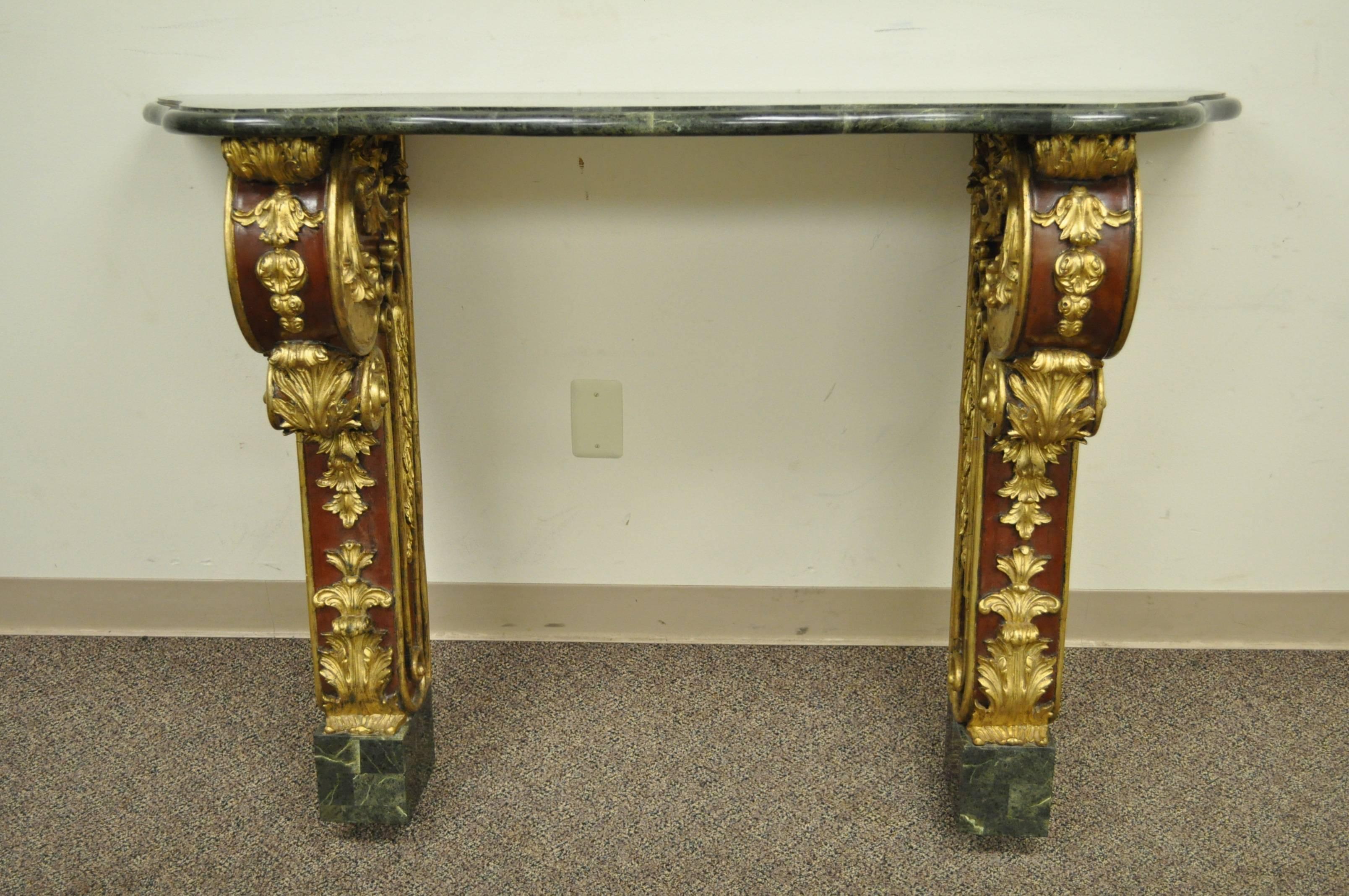 A beautiful 20th century French Rococo or Louis XV style wall-mounted console or hall table. Item features a mahogany frame, extravagant giltwood accents, and tessellated stone top and feet. The table has a wonderful contrast between the brilliant