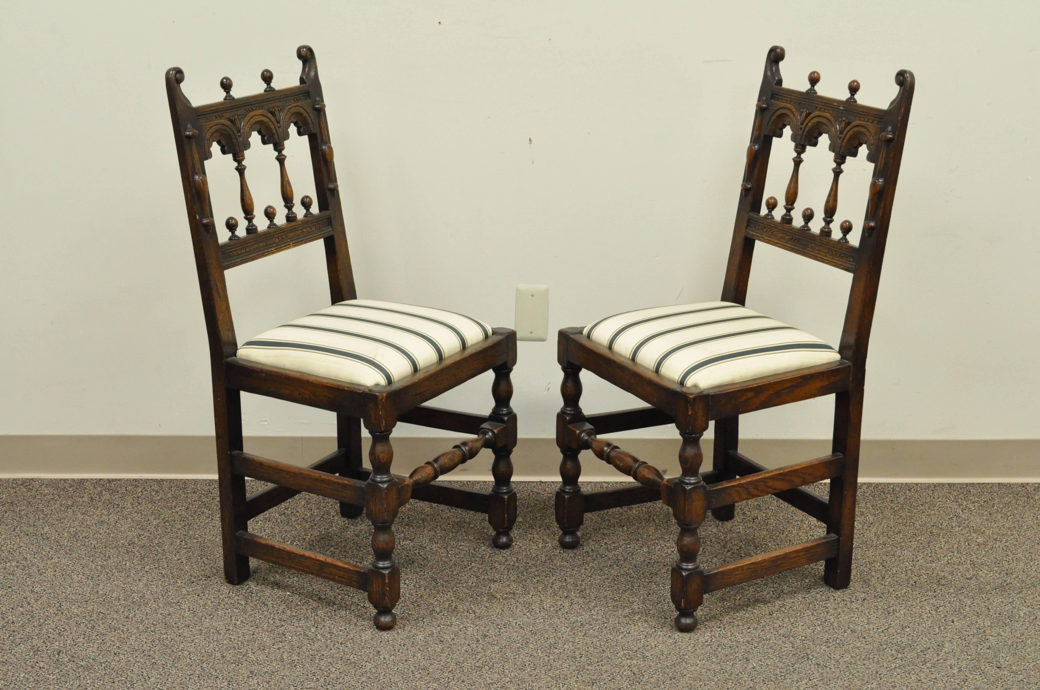 Quality set of eight Vintage Solid Carved Oak Jacobean or Gothic Style Dining Chairs, circa 1930s. Set consists of 6 side chairs and his and her armchairs (slight variation in detail and size). Set features uniquely carved backs, turned legs,