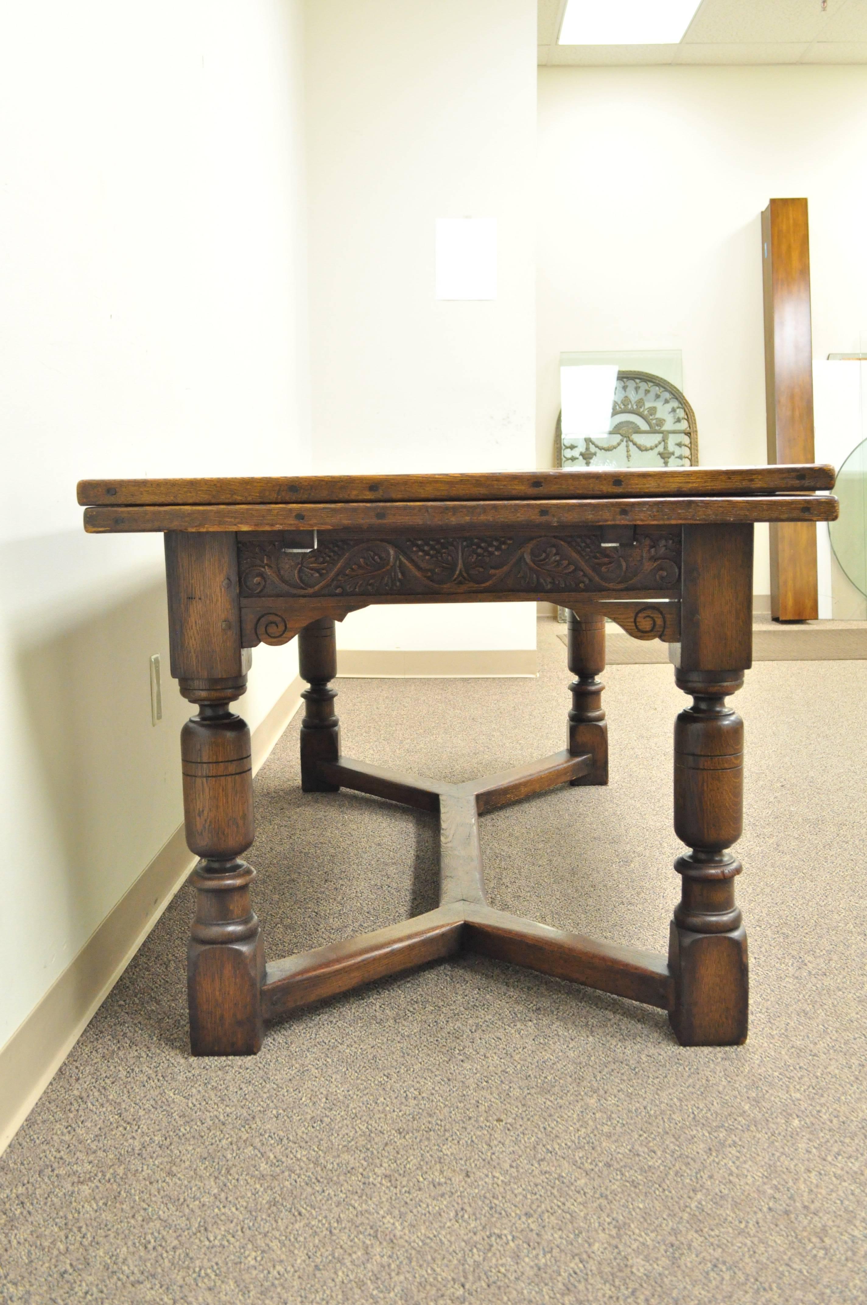 1930s Solid Carved Oak Jacobean Style Refectory Extension Plank Dining Table In Good Condition In Philadelphia, PA