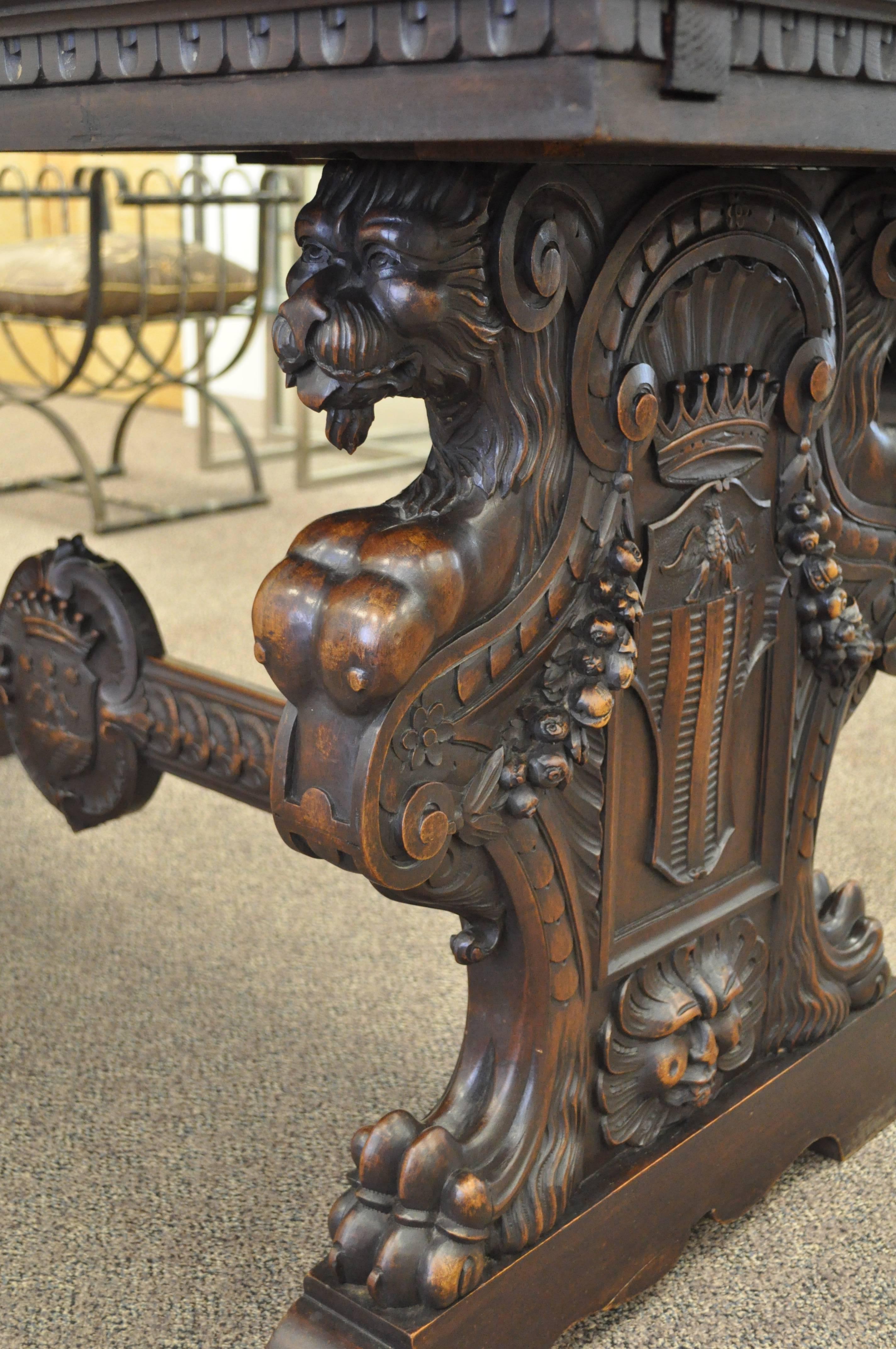 Solid walnut Renaissance Revival trestle table which features carved trestle ends depicting griffins with female busts, northwind faces, shields, crowns and floral drapes, united by a carved stretcher. Table can be used in many ways including use as