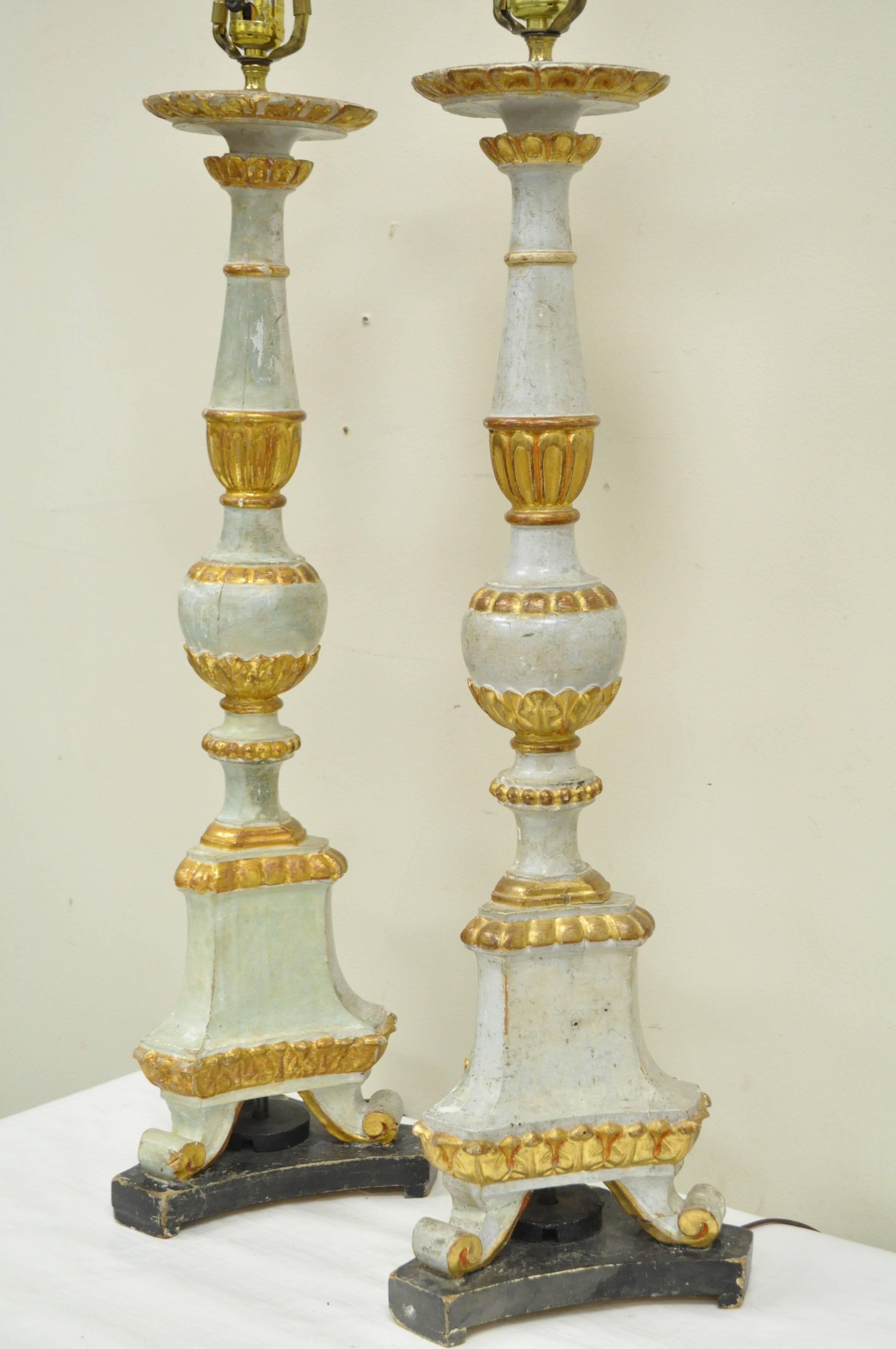 Zwei italienische, handgeschnitzte, paketvergoldete Tischlampen aus Massivholz im neoklassischen Stil aus dem frühen 20. Originales italienisches Etikett auf der Oberseite der Lampen. Lampen haben bemerkenswerte alte Welt Charakter mit Zeichen der