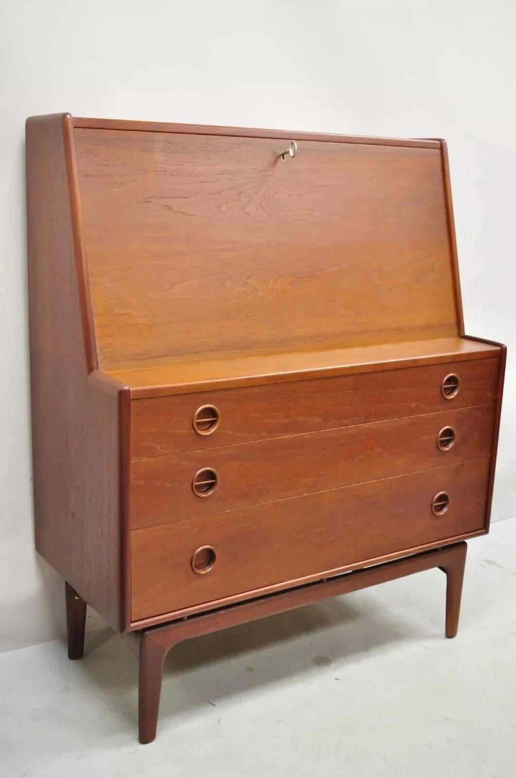 Vintage Mid Century Danish Modern Arne Hovmand Olsen MK Teak Drop Front Secretary Desk. Item features a sculpted wood floating base, drop front lid with fitted interior, beautiful wood grain, original label, working lock and key, 3 dovetailed