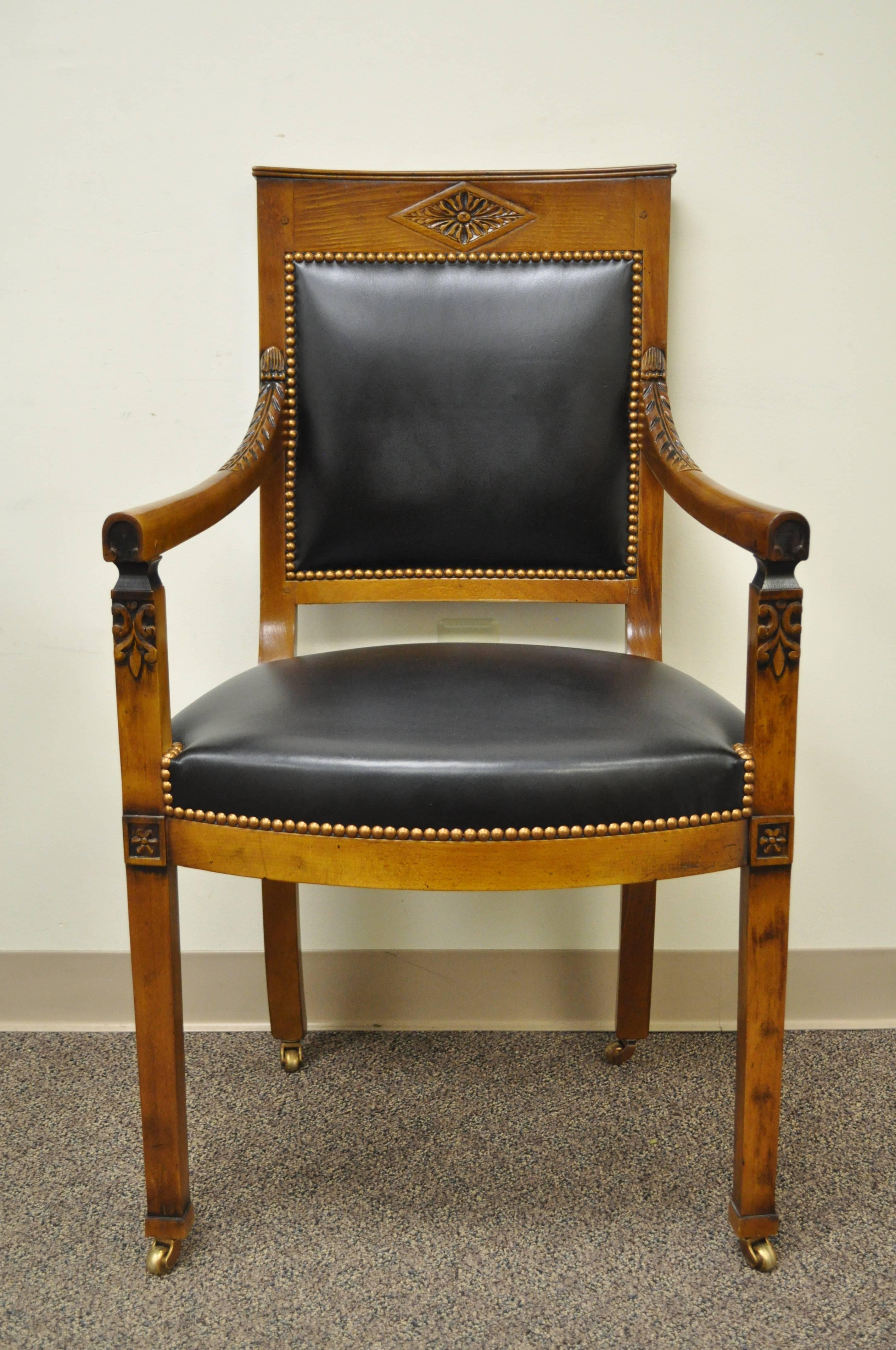 Custom quality solid hand-carved Cherry Fauteuil on brass rolling casters. Armchair features a lightly carved solid cherry frame, black leather upholstery, nailhead trim, and brass rolling casters. The cherry wood is finished with a desirable and