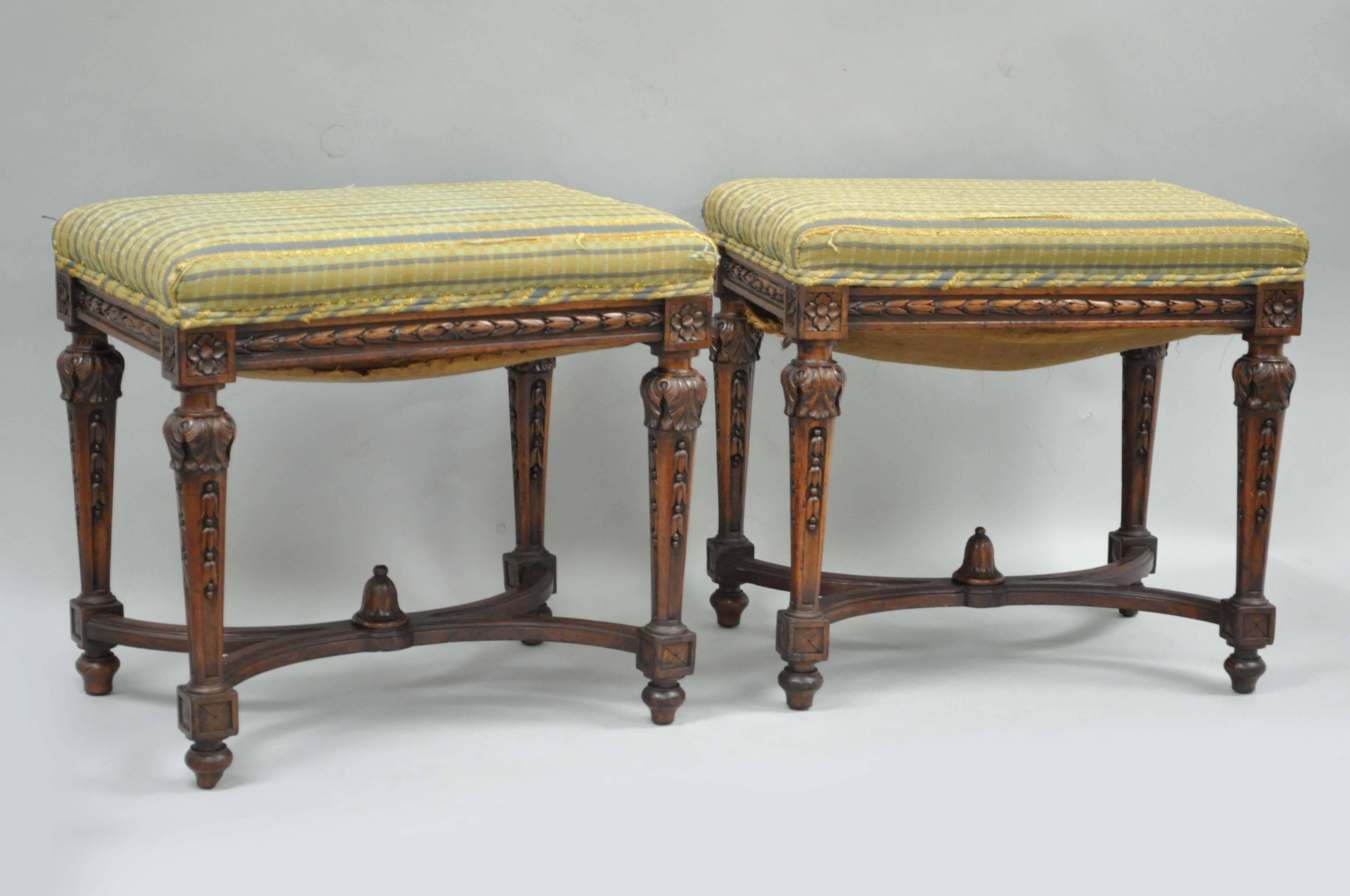 Quality pair of antique Victorian carved walnut French Louis  XVI style benches or stools with carved stretcher bases. Stools feature medallion, bell flower and acanthus carved frames with elegant and Classic form.