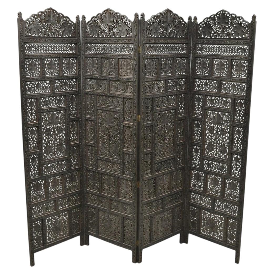 Paravent pliant vintage anglo-indien en bois de teck sculpté, composé de 4 panneaux