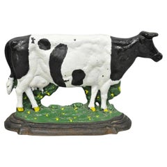 Grande fermaporta figurativo in ghisa verniciata, raffigurante una mucca da latte in bianco e nero d'epoca