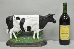 Grande fermaporta figurativo in ghisa verniciata, raffigurante una mucca da latte in bianco e nero d'epoca
