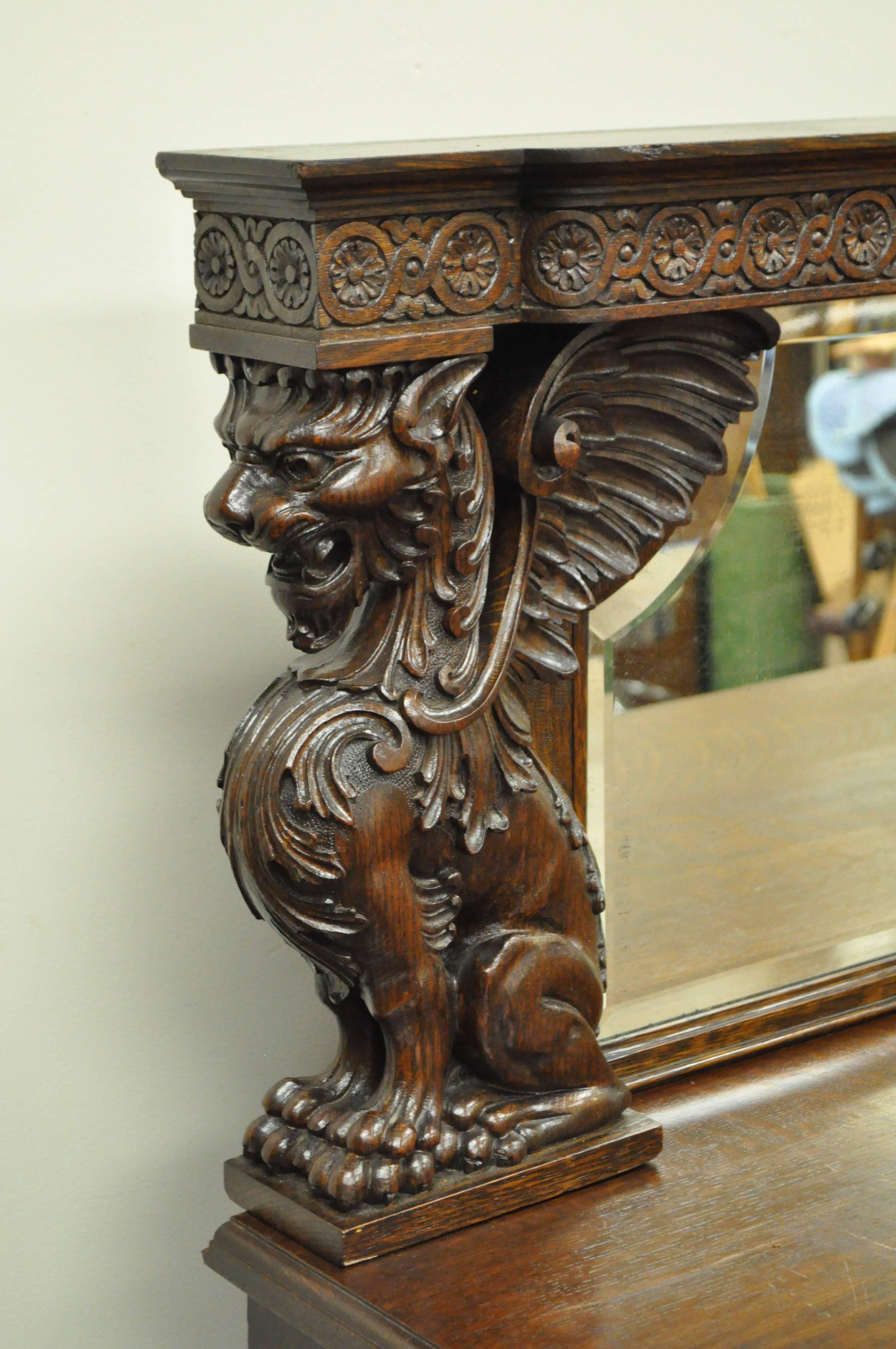 19th century Victorian Quartersawn oak figural sideboard with shaped beveled mirror. Possibly by RJ Horner NY. Item features full winged griffins and lion carved columns, beautiful quartered oak construction, paw feet, lower drop front with hidden