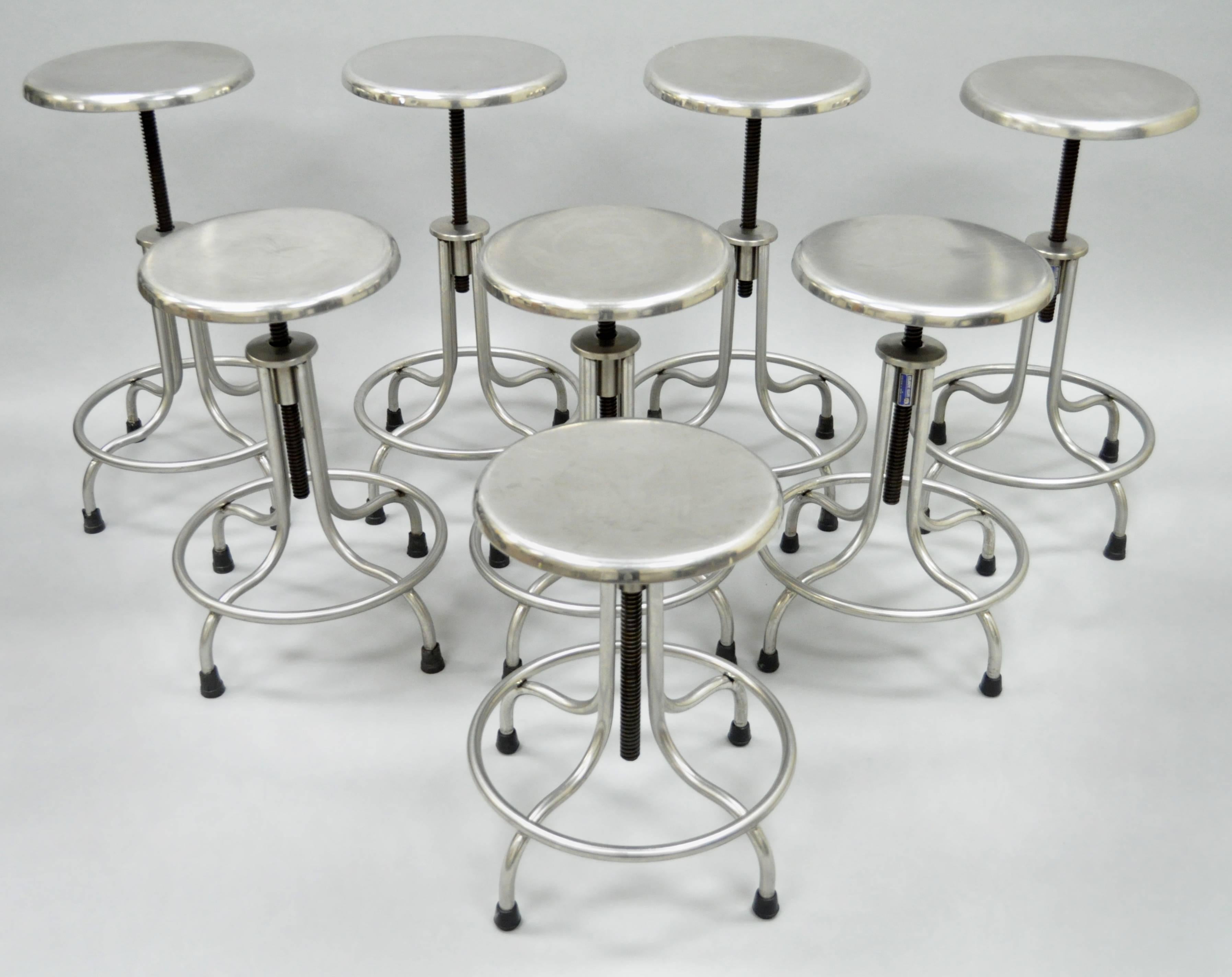 Original vintage stainless steel swivel adjustable height stool or bar stool with footrest by Atlantic Alloy Industries Inc. (AAI) of Union, New Jersey. This well-constructed American made medical or dental stool features a polished solid steel