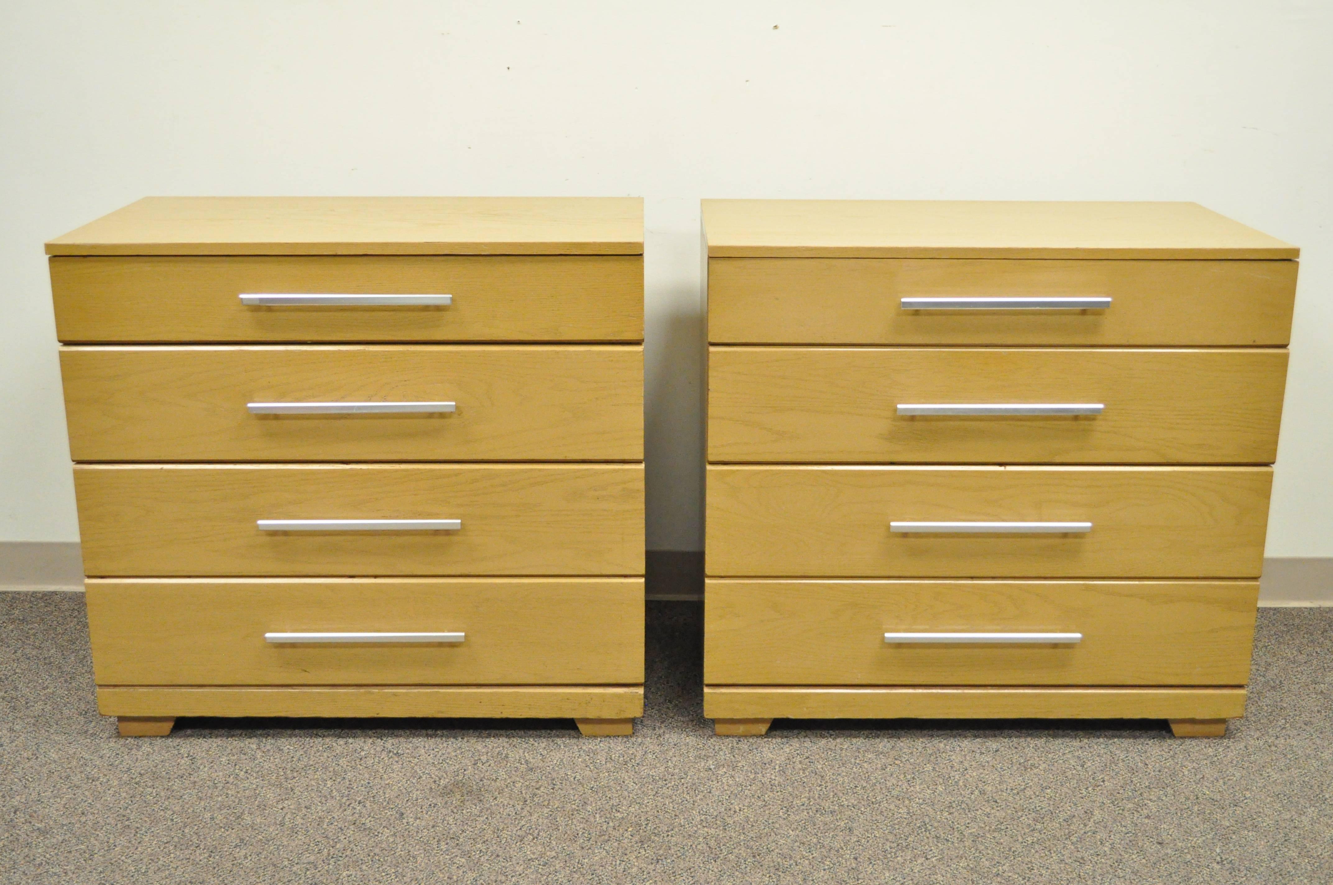 Pair of oak Mid-Century Modern bachelor chests designed by Raymond Loewy for Mengel. Each chest features clean modernist lines, four drawers, aluminum hardware, original oak finish, raised on straight legs. Very hard to find a matching pair.