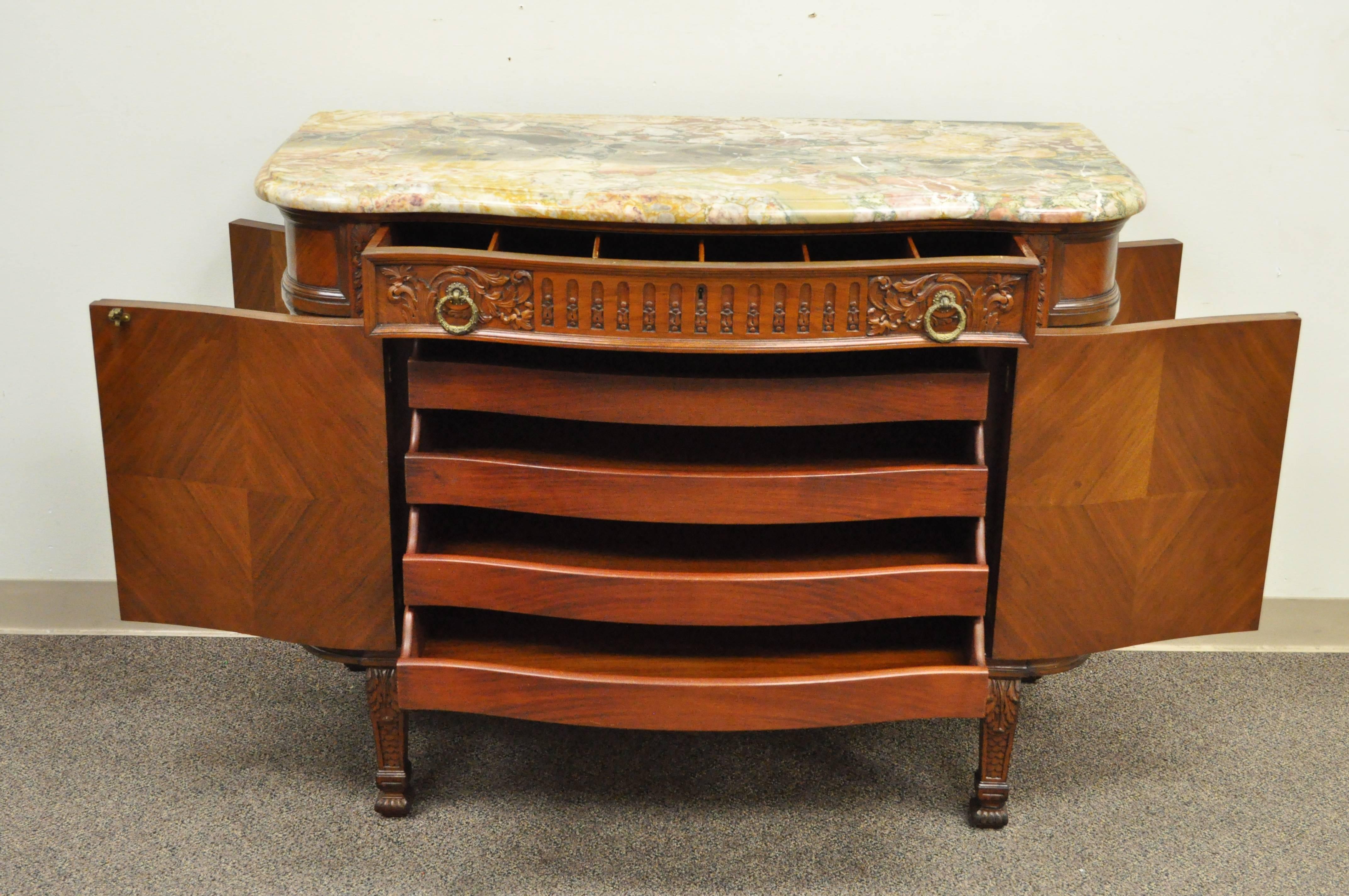 Stunning antique French Renaissance carved walnut and satinwood inlay marble top demilune server, circa first quarter 20th century. This cabinet or buffet features hidden doors on the sides, beautiful carvings and satinwood inlay throughout, shapely