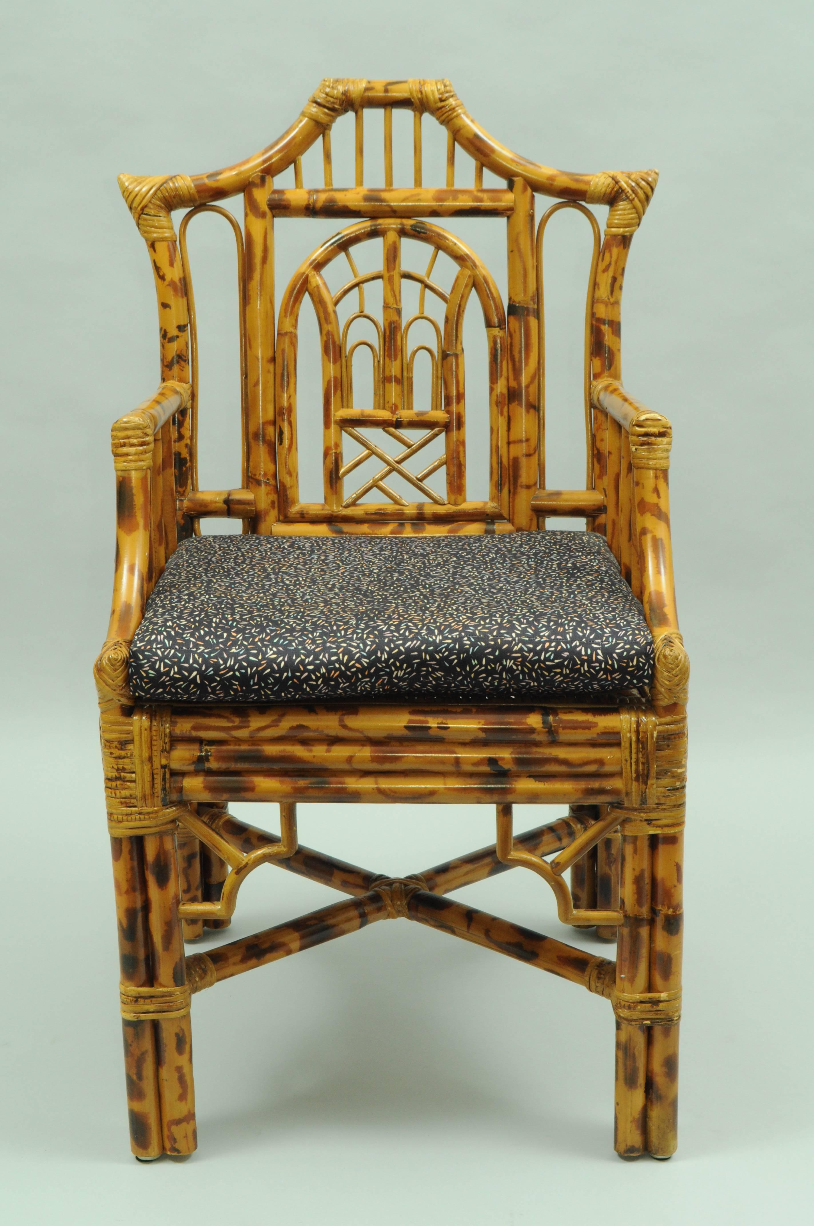 Vintage bamboo armchair in the Chinese Chippendale style. Item features a bamboo reed frame, ornate pierced design, woven seat, loose cushion, pagoda form back, stretcher base, and great chinoiserie corner accents. Possibly by Maitland Smith. Marked