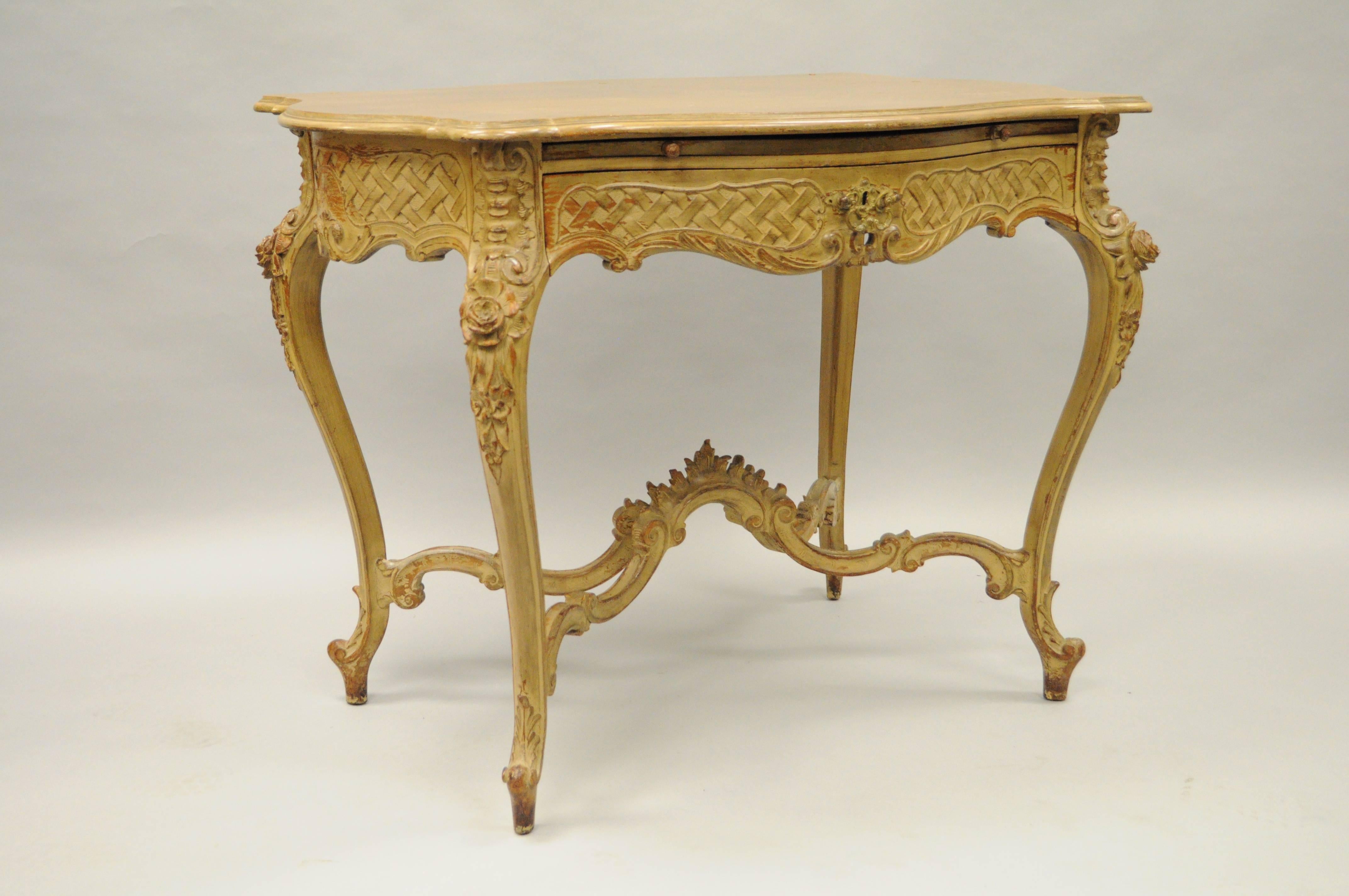 Antique French Louis XV / Rococo style hand-carved and distressed dressing table / ladies writing desk. Item features a shaped turtle top with diamond sunburst veneer, single hand dovetailed drawer, pull-out velvet surface, ornate stretcher