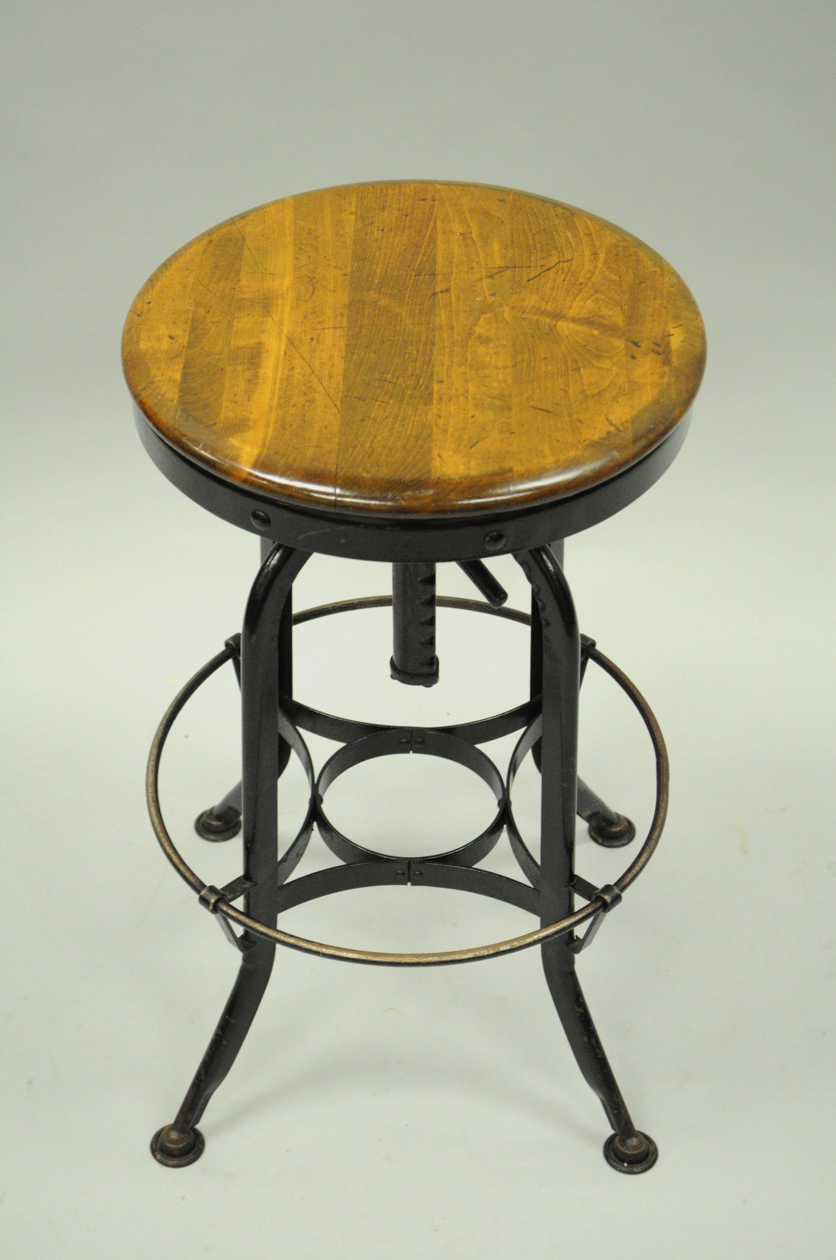 Vintage adjustable wood and metal architect's / engineers draftsman stool by Defiance Sales Corp. Item features a solid wood round butcher block seat, steel adjustable base with footrest, and authentic Industrial form. Original label on the