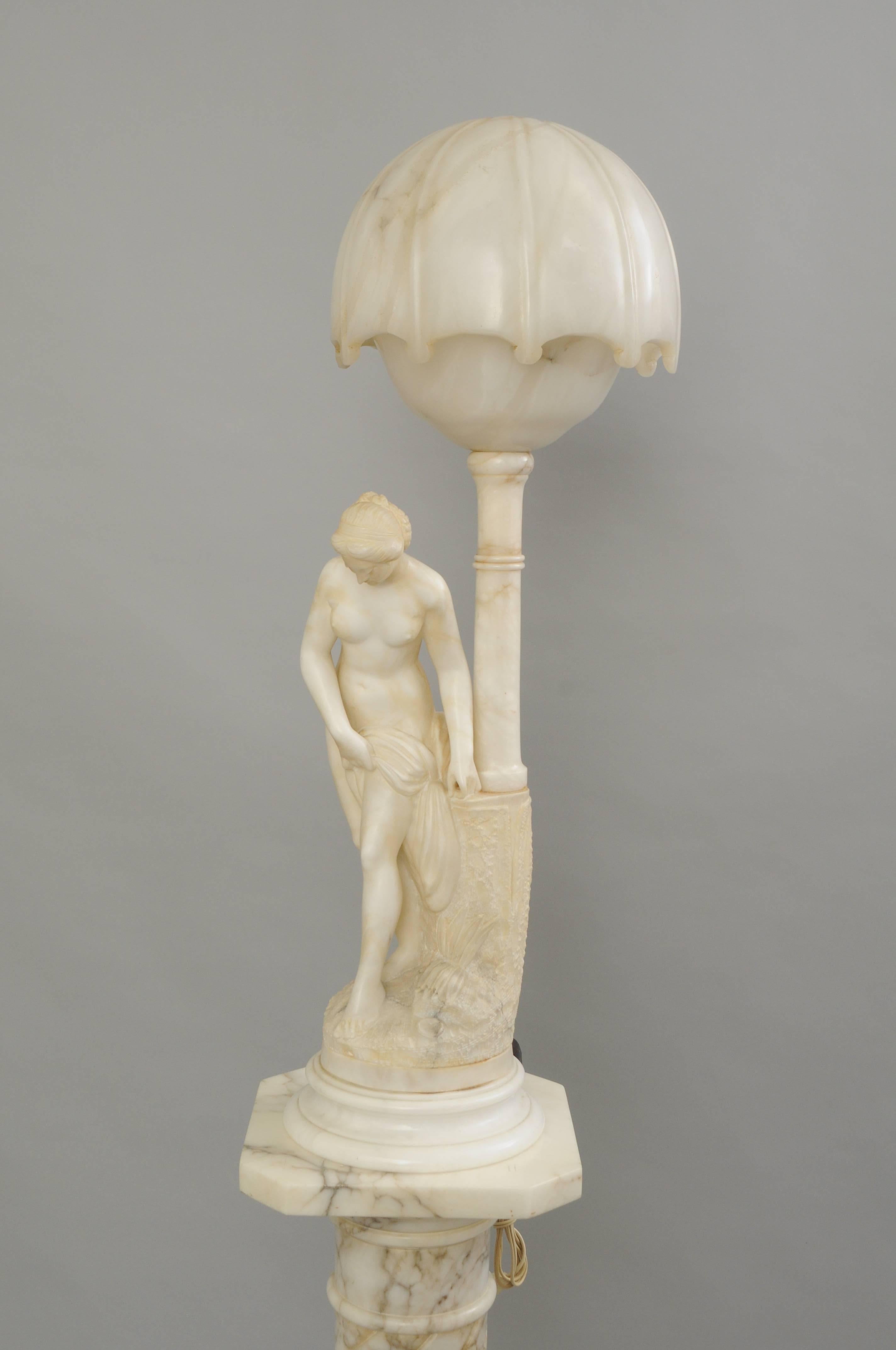 Impressive figural marble and alabaster orientalist lamp and pedestal with signature. Item features a carved marble and alabaster figure of a nude gypsy woman standing under a street lamp with illuminating single socket fixture. The lamp rests on a