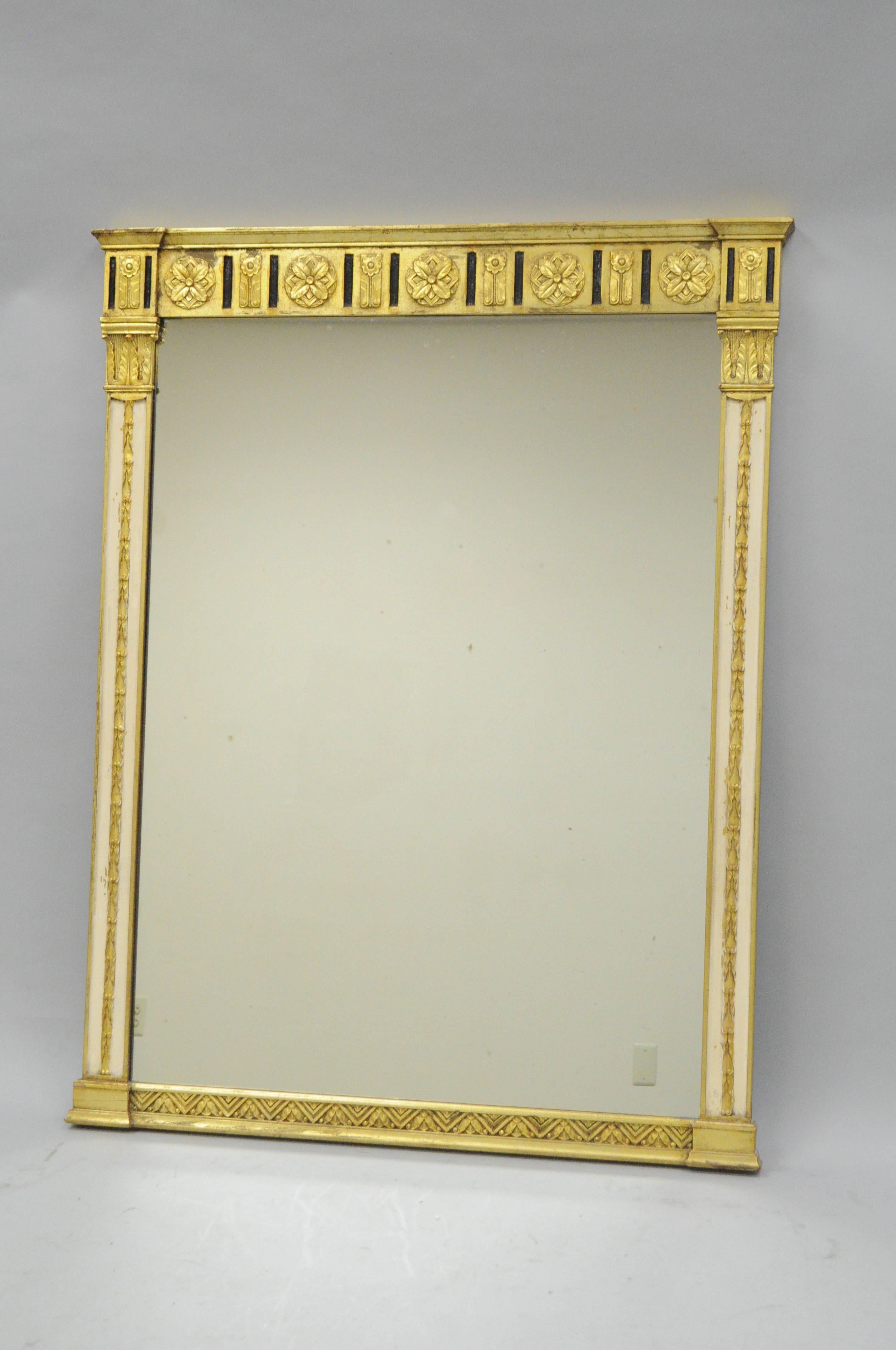 Impressive early 20th century Italian Classical style gold giltwood rectangular wall mirror. Item features a giltwood frame with gold, black, and cream accents, and very nice quality and form. Great for use as a pier mirror or above a console or