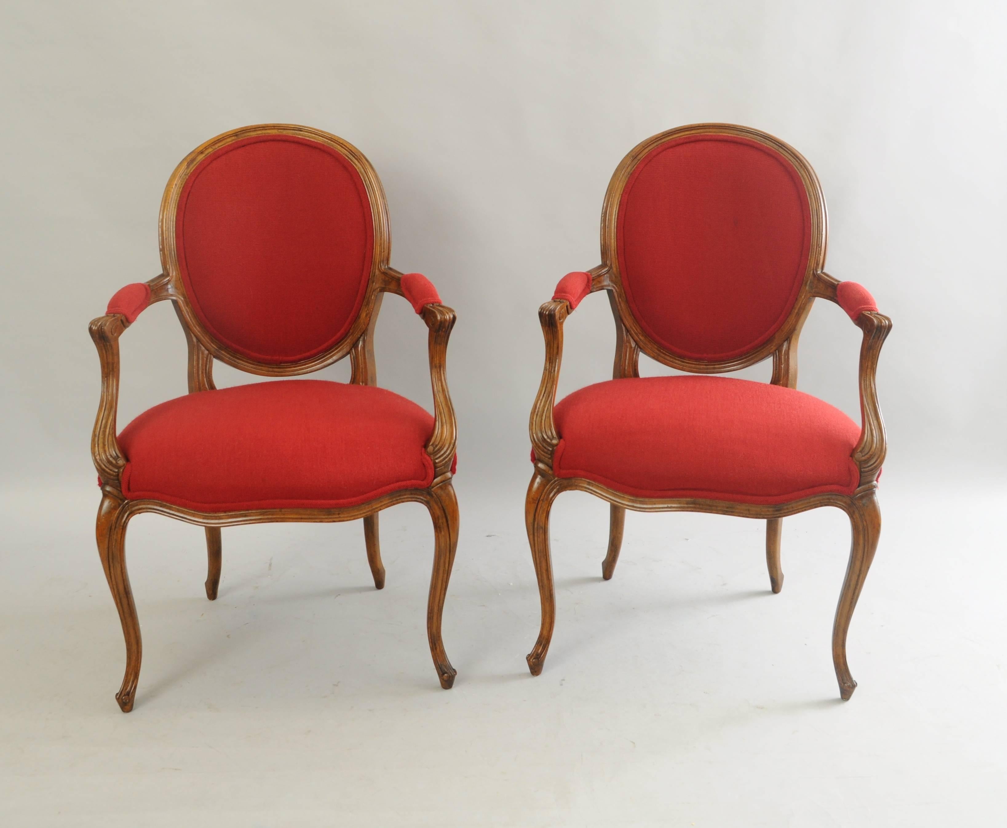 Pair of vintage baker French country / Louis XV style armchairs. Item features solid wood construction, upholstered oval backs, cabriole legs, red upholstery, contrasting rear upholstery, original Baker label, sweeping arm and leg carvings, elegant