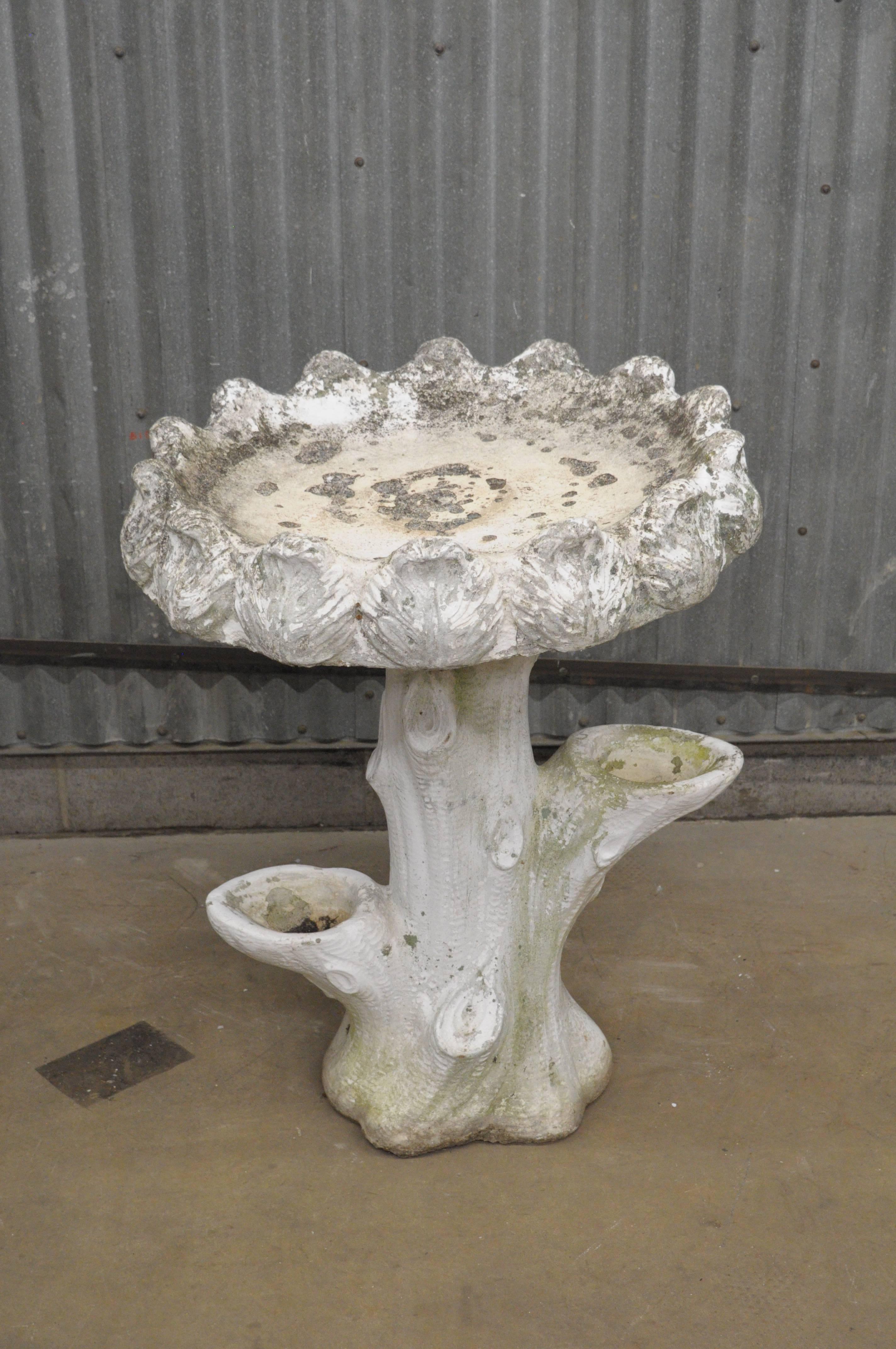 Antique faux bois French style cast cement concrete two part garden bird bath. Item features an ornate basin with fancy leafy border and faux bois tree branch form pedestal base. Bird bath has achieved a very nice aged weathered patina over the