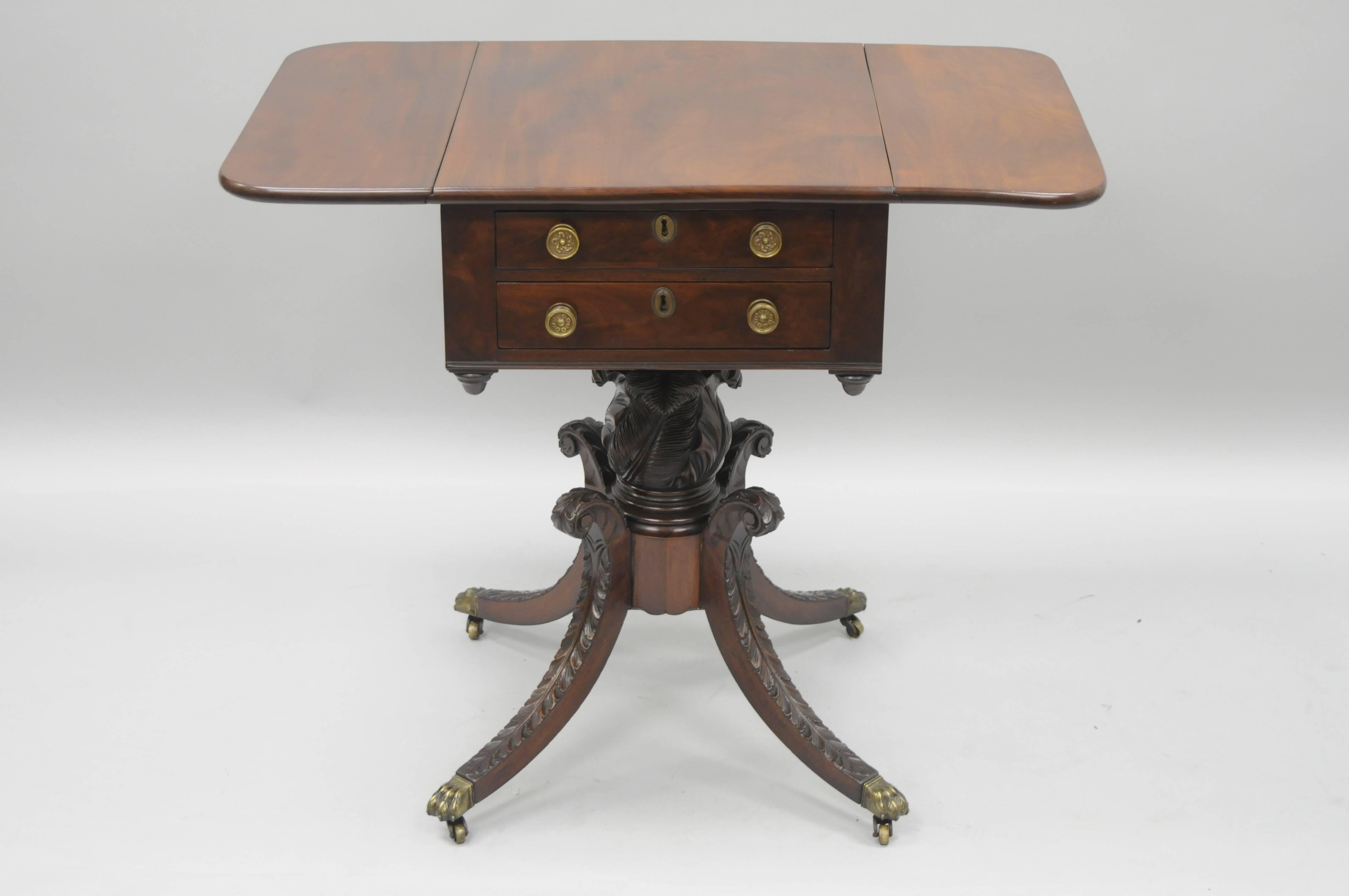 Antique early to mid 19th century regency / empire carved mahogany drop-leaf two-drawer side table with faux drawers at the rear. Table features a solid mahogany wood top with beautiful wood grain, drop sides, and two hand dovetailed drawers at the