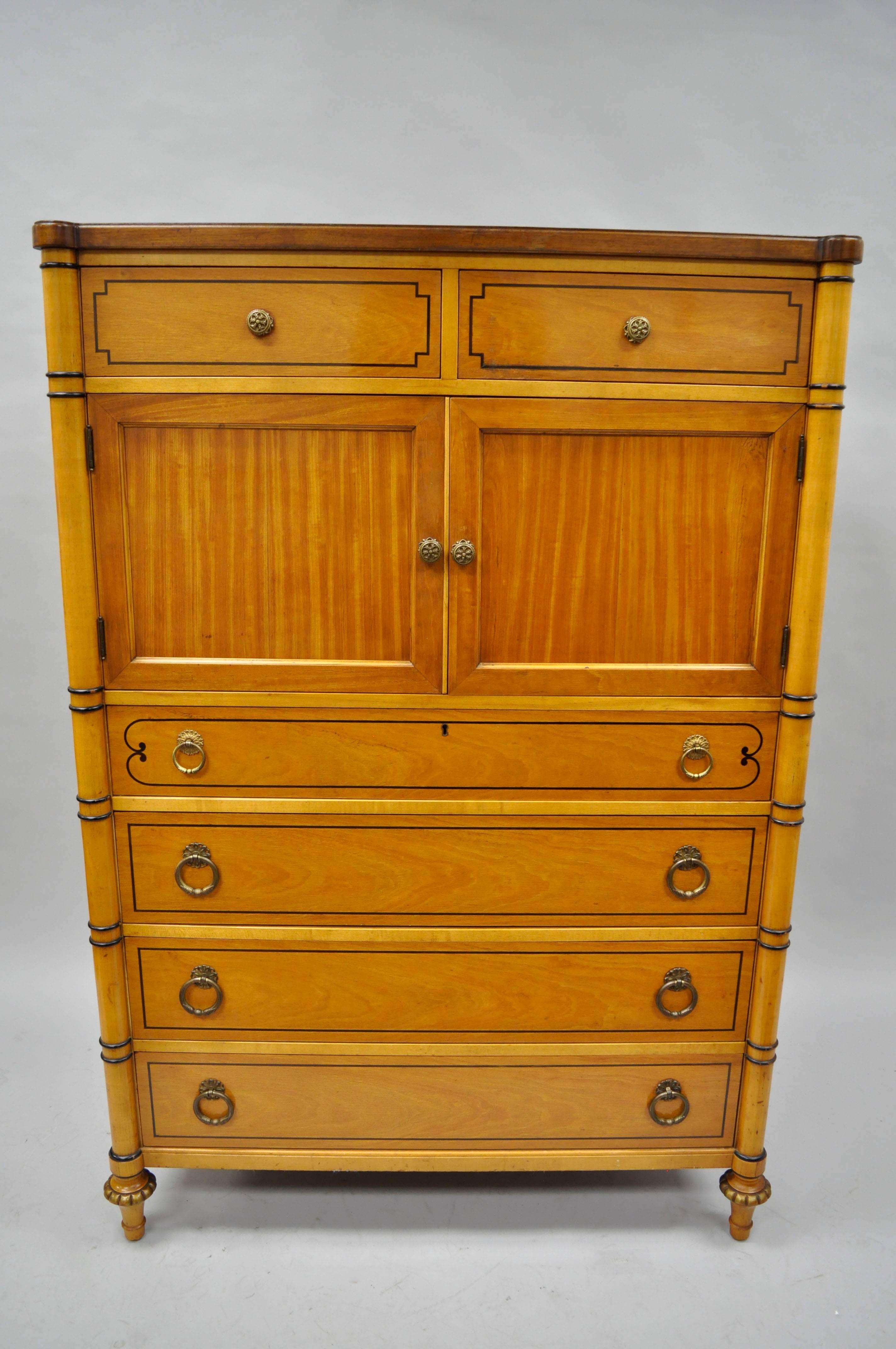 Beautiful vintage Kittinger French Louis XVI / Regency style tall chest cabinet in walnut with stunning rosewood veneer top. Item features nine dovetail constructed drawers, two upper cabinet swing doors, black paint decorated accents, brass drop
