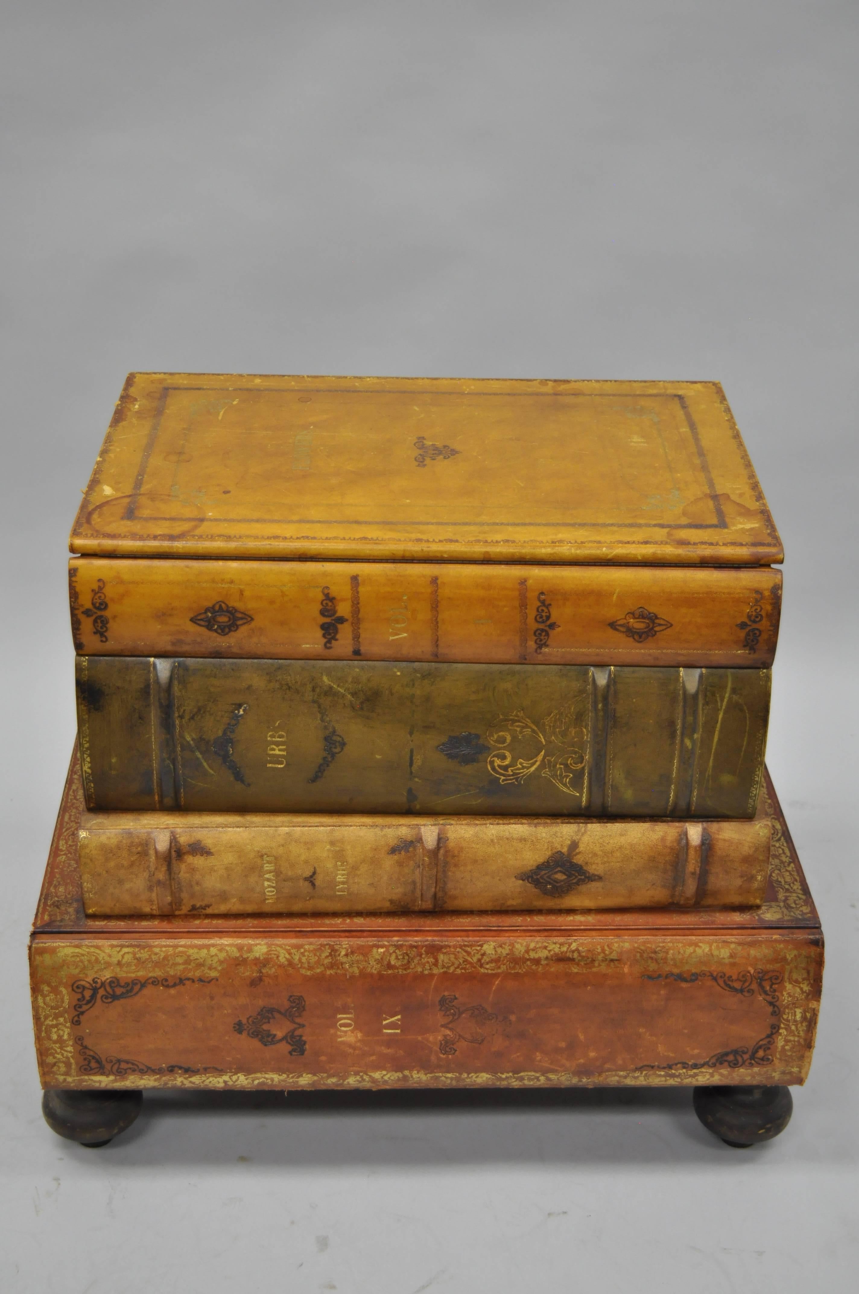 Vintage Italian florentine leather stacked book form side table by Sarreid. Item features a painted and gold gilt tooled leather wrapped frame, lift top, single drawer, decorated interior, wooden bun feet, and desirable antiqued/distressed finish.