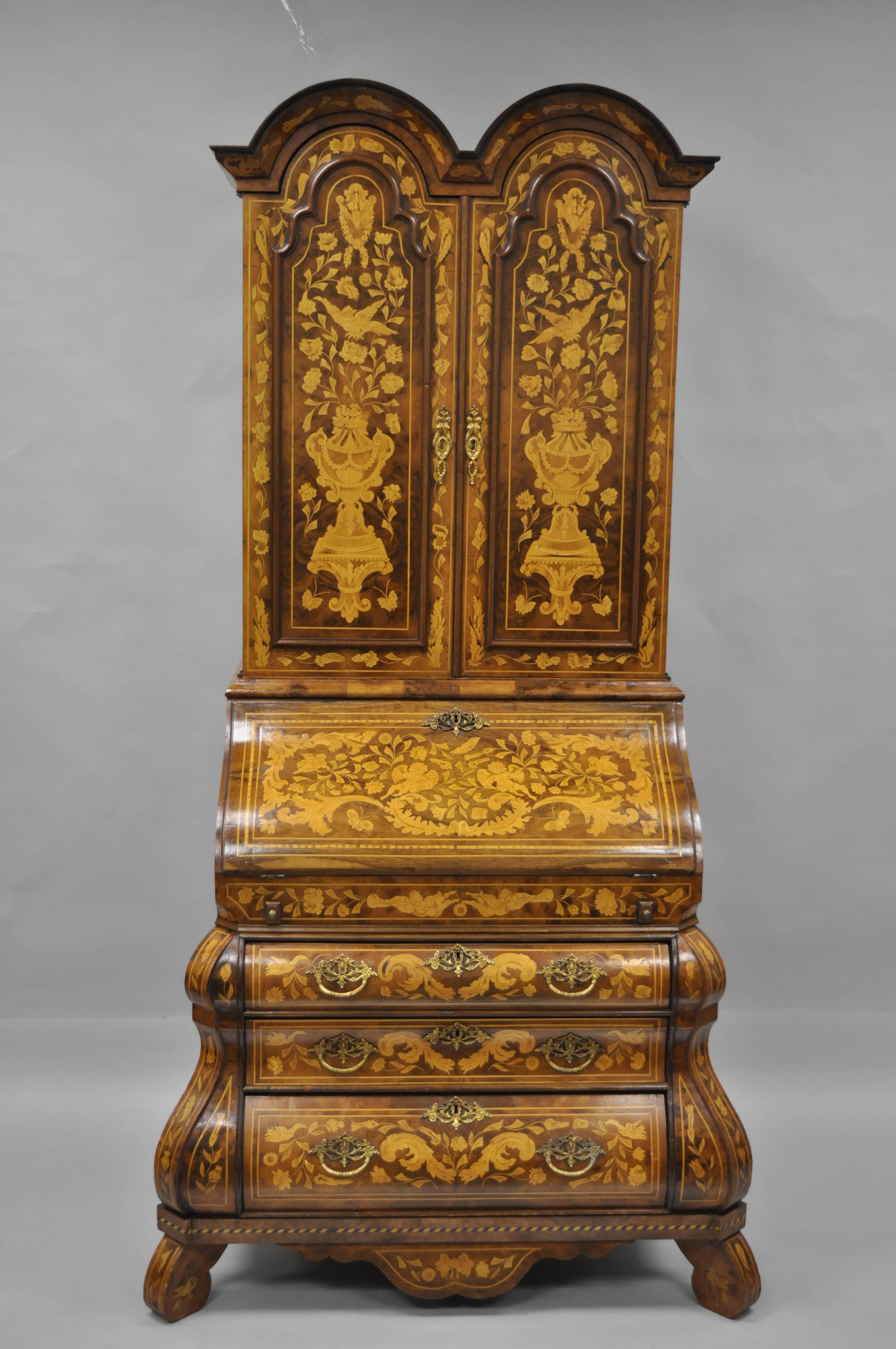 Truly impressive, mid-20th century, Dutch marquetry style inlaid and burl wood secretary desk. Item is inlaid from top to bottom including the front, sides, and interior with varying floral scroll work, flowers, winged cherubs, oxen, urns and