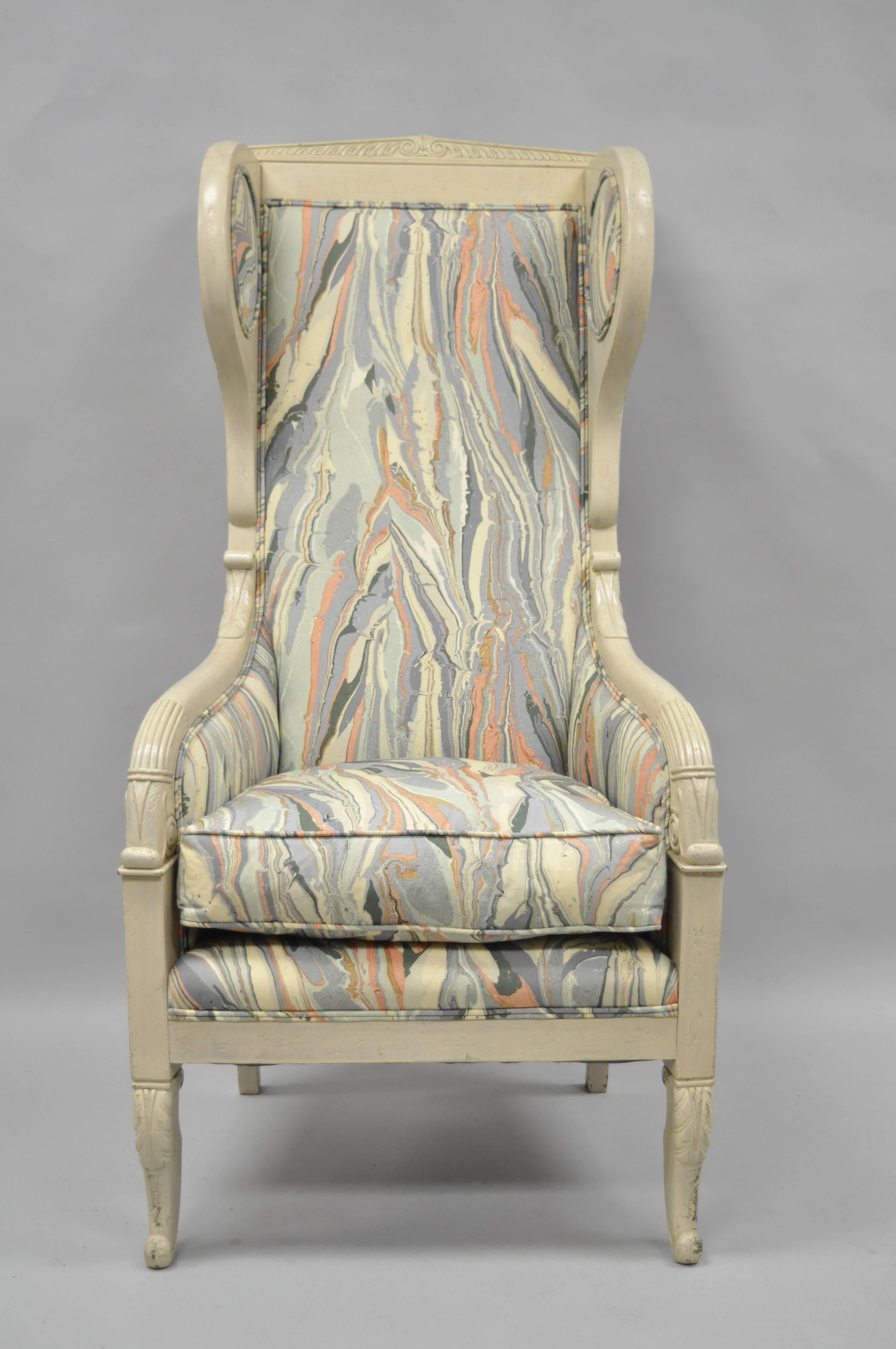 Vintage high back French Empire / neoclassical style lounge chair with marbled fabric. Item features a tall solid carved wood frame, unique upholstered wings, shapely legs, cream distressed finish, and multi-color marbled fabric with pinks, blues,