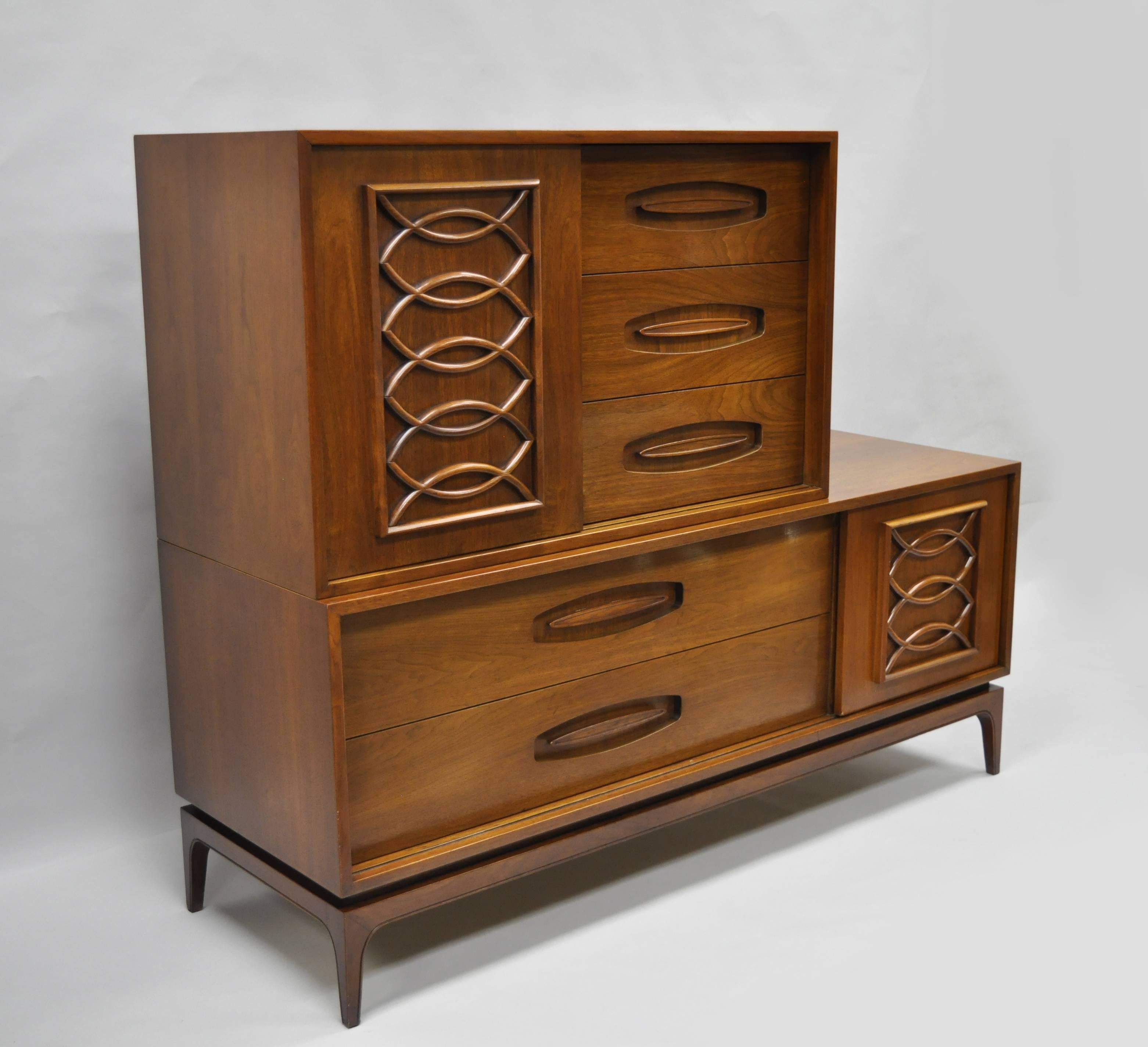 Vintage Mid-Century Modern walnut two-piece sliding door dresser chest by Castleton Furniture. Item features two part construction, ten drawers, sliding doors on upper and lower section with shaped wood moldings, tapered legs, sculpted wood inset