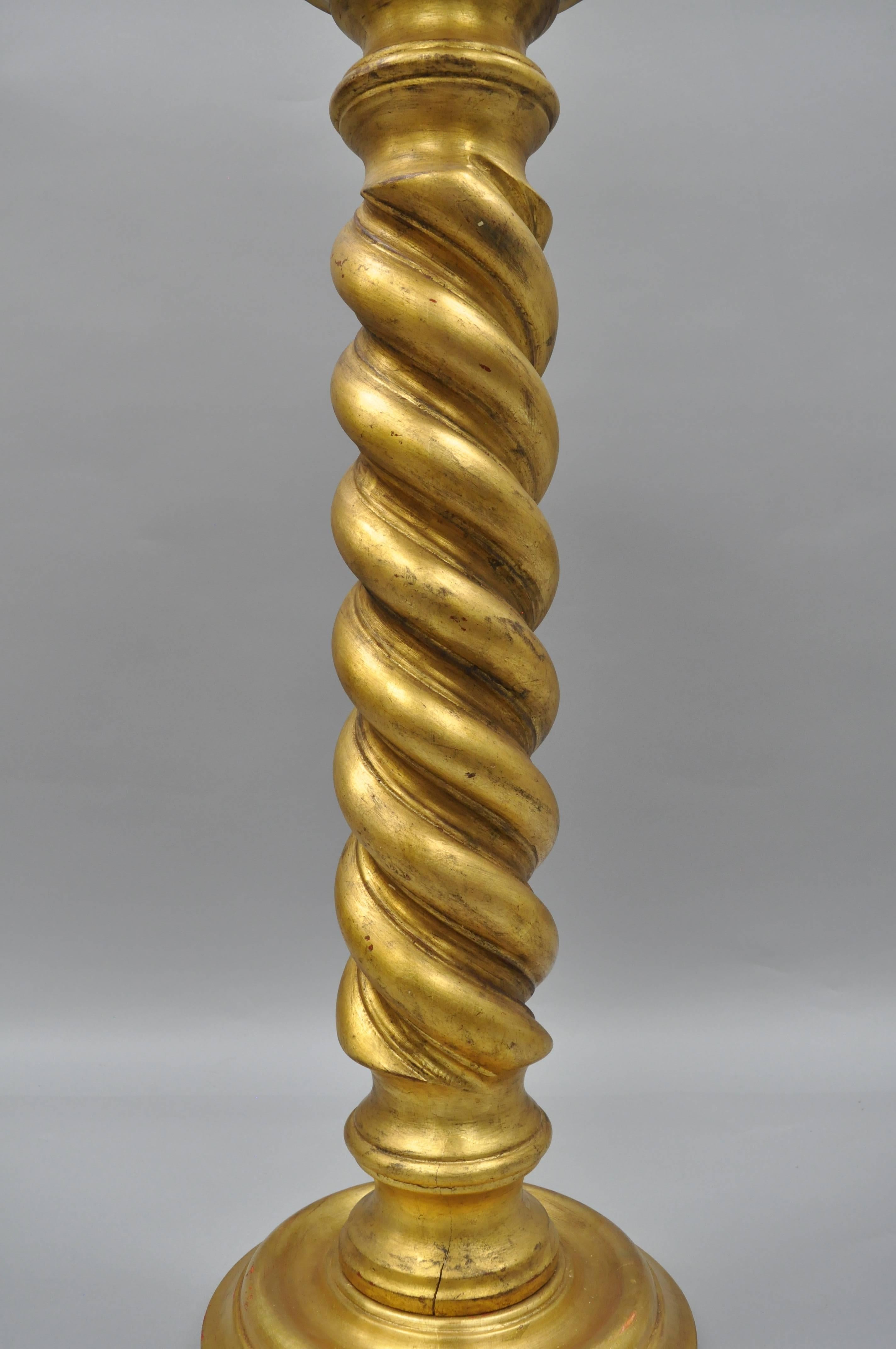 Vintage Italian Solid Carved Wood Gold Leaf Spiral Column Pedestal Stand. Item features a solid wood form, round top, distressed / antiqued gold leaf finish, and pedestal base supported by three feet. Great for statues or as a plant stand. 39"H