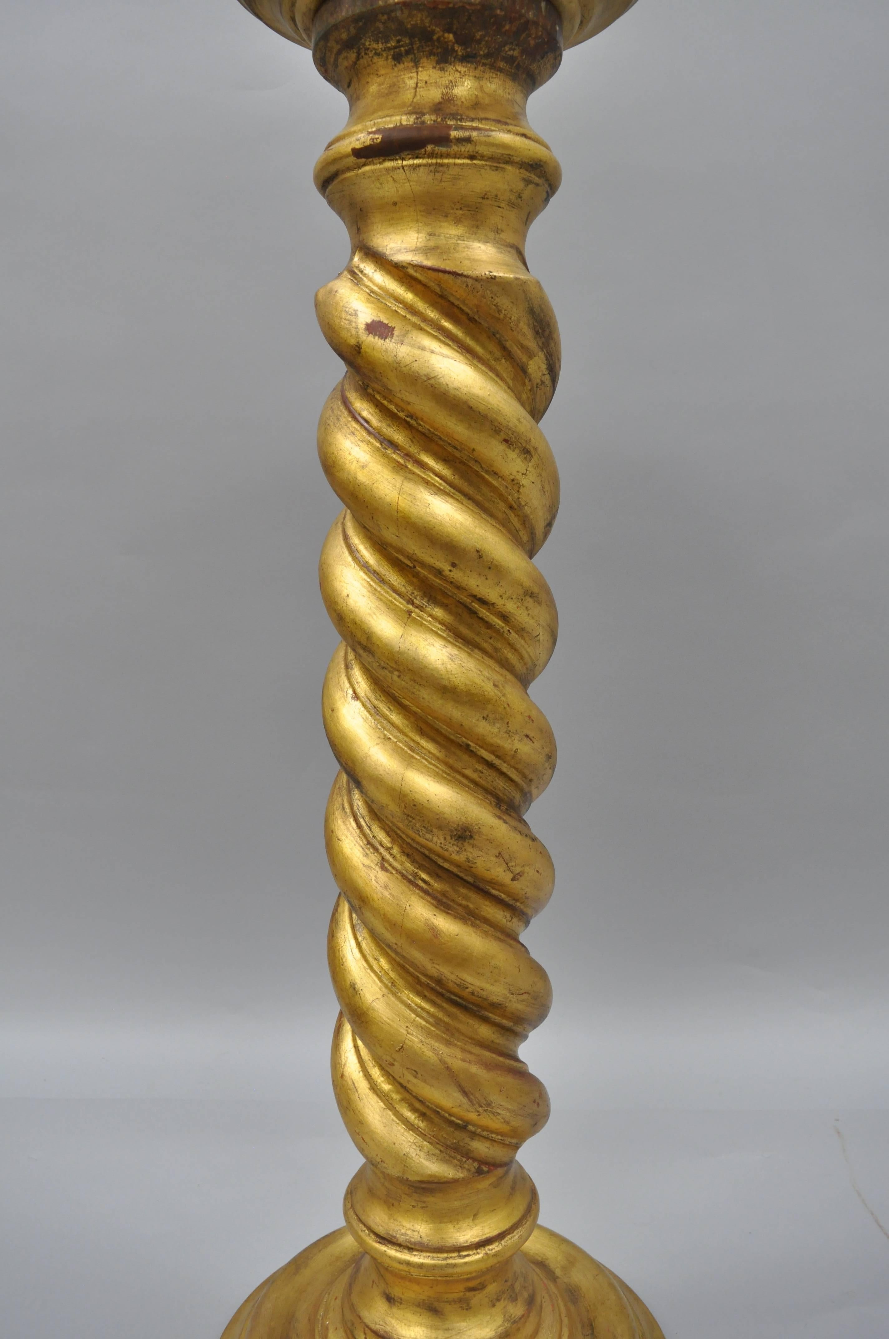Vintage Italian Solid Carved Wood Gold Leaf Spiral Column Pedestal Stand. Item features a solid wood form, round top, distressed / antiqued gold leaf finish, and pedestal base supported by three feet. Great for statues or as a plant stand. 39"H