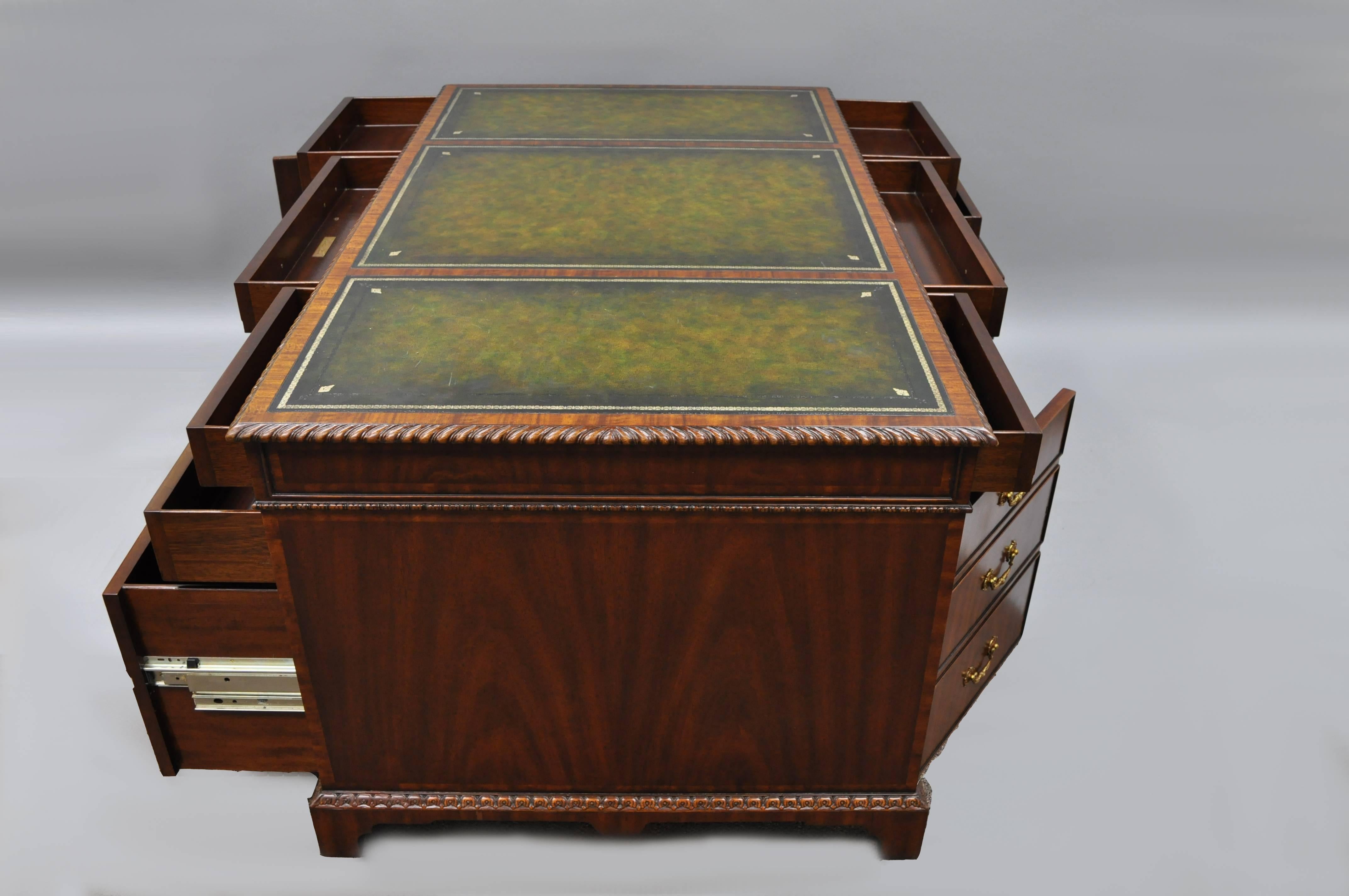 Stately Mahogany 3 part executive partners desk with green tooled leather top by Maitland-Smith with working drawers / doors on both sides. Item features five drawers and one-door on each side, green tooled leather top, carved rope edge, solid brass
