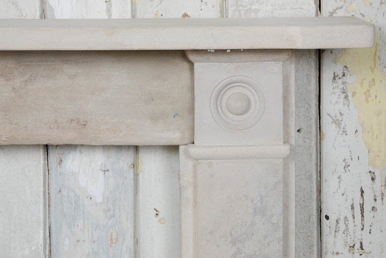 A reclaimed Georgian style fireplace surround in a light sandstone. The surround has a plain bullseye design with carved roundels at each end block.

Opening: 34.5